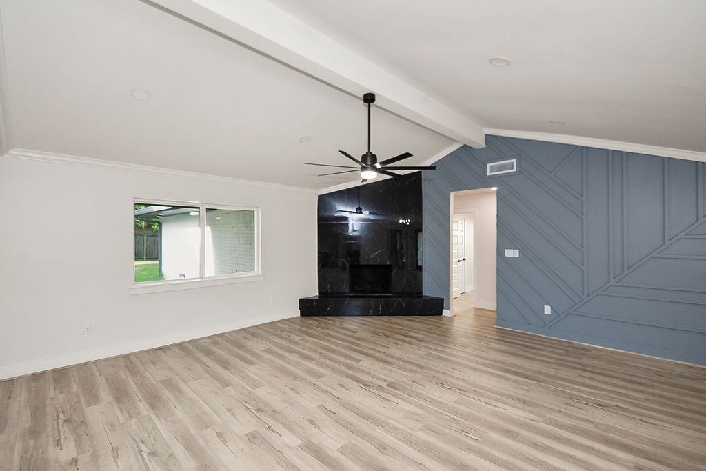 6106 Rutherglenn Drive, Houston, TX 77096 Spacious living room with dramatic vaulted ceilings and seamless flow into the entertaining spaces.