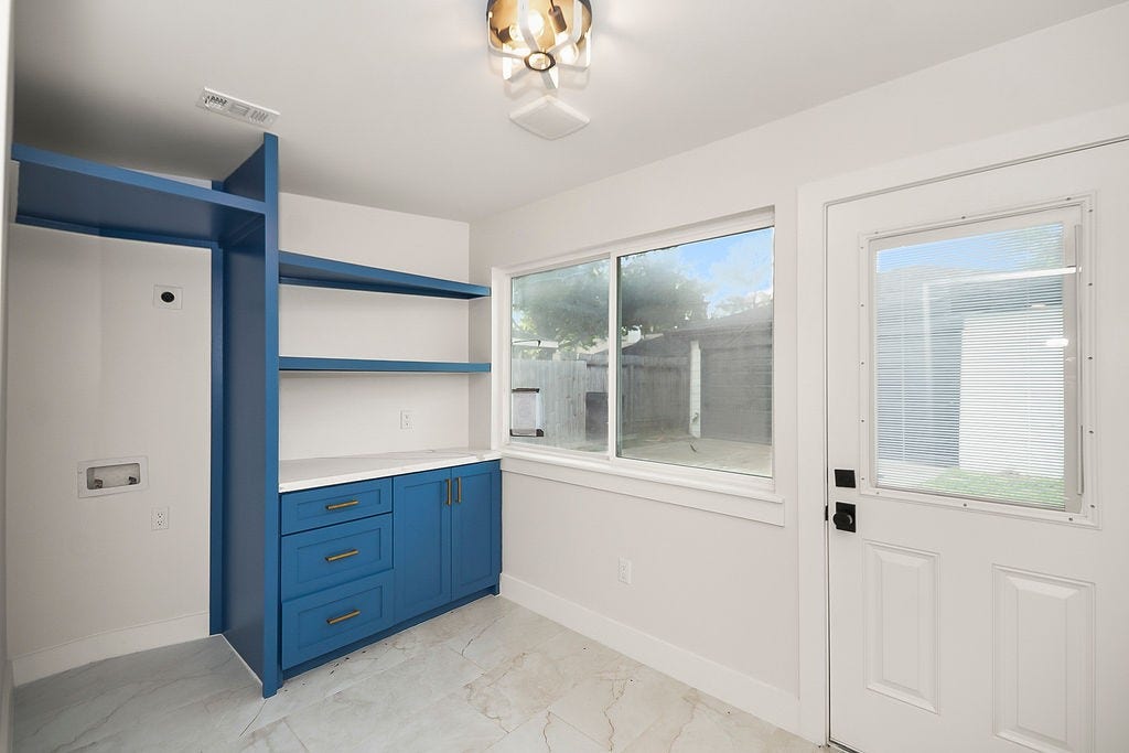 6106 Rutherglenn Drive, Houston, TX 77096 Flexible bonus room with built-in shelving and abundant natural light, perfect for a home office or study area.