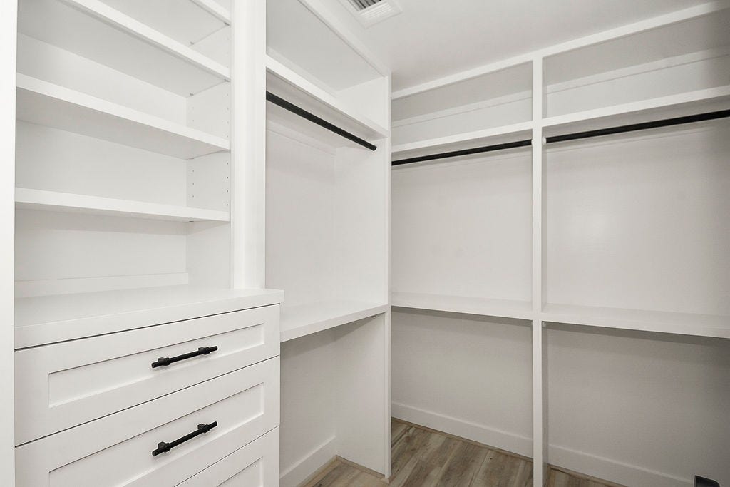 6106 Rutherglenn Drive, Houston, TX 77096 Another view of the spacious custom closet with built-in storage solutions throughout.