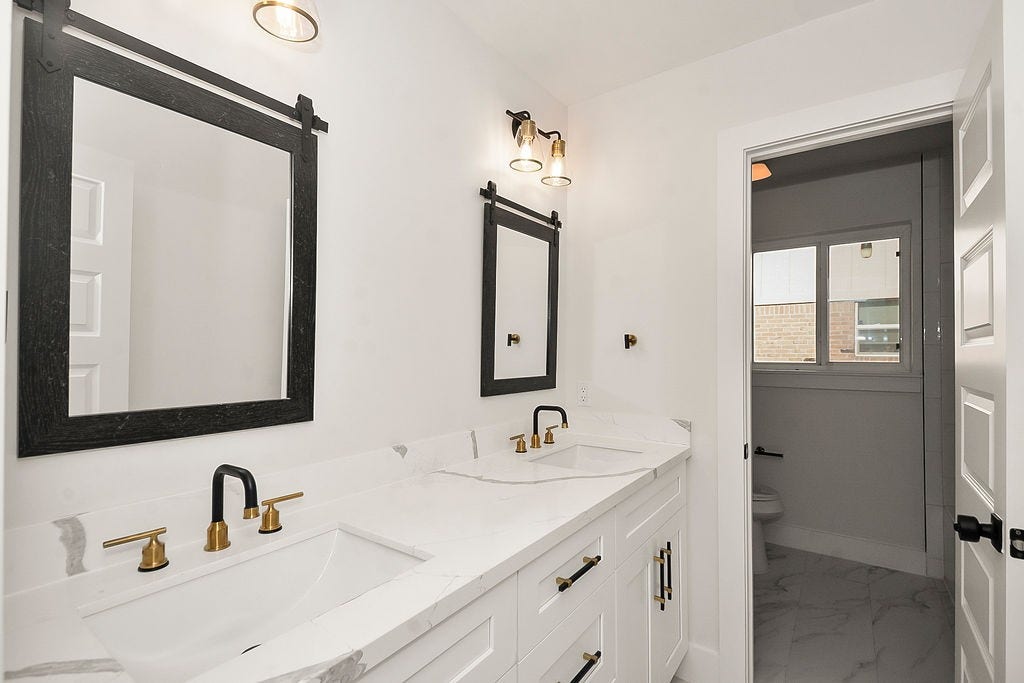 6106 Rutherglenn Drive, Houston, TX 77096 Stylishly updated bathroom vanity with modern fixtures and contemporary design details.