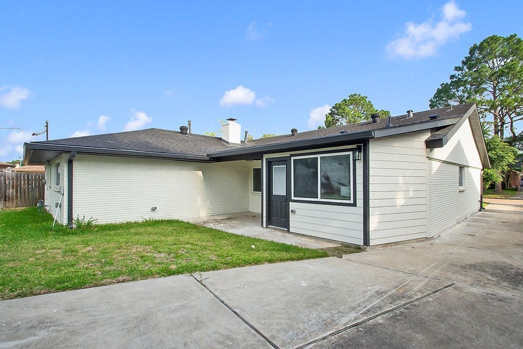 6106 Rutherglenn Drive, Houston, TX 77096 Another view of the spacious backyard and patio area with plenty of room for outdoor gatherings.