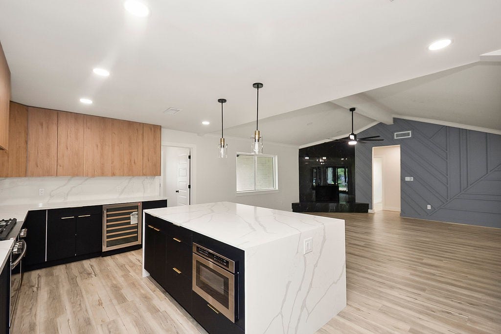 6106 Rutherglenn Drive, Houston, TX 77096 Another view of the stunning kitchen showcasing premium finishes and expansive prep space.