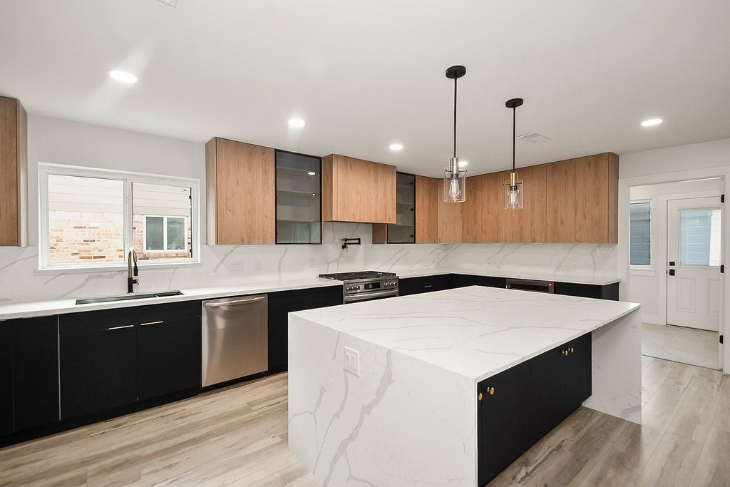 6106 Rutherglenn Drive, Houston, TX 77096 Another angle of the beautifully updated kitchen with modern finishes and open entertaining layout.