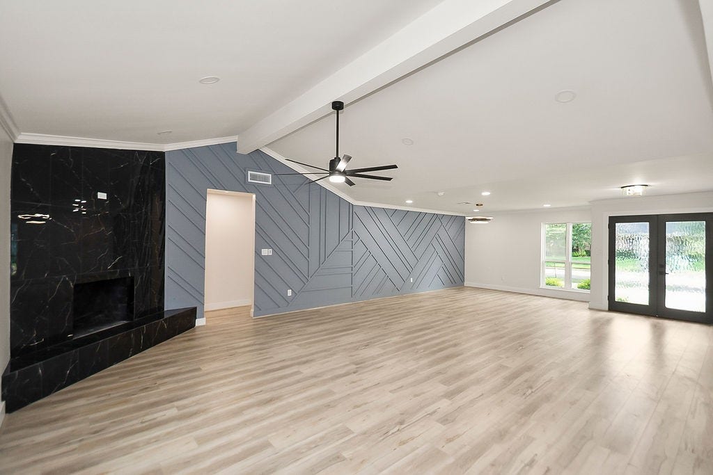 6106 Rutherglenn Drive, Houston, TX 77096 Bright open-concept living area featuring vaulted ceilings, engineered hardwood flooring, and modern finishes.
