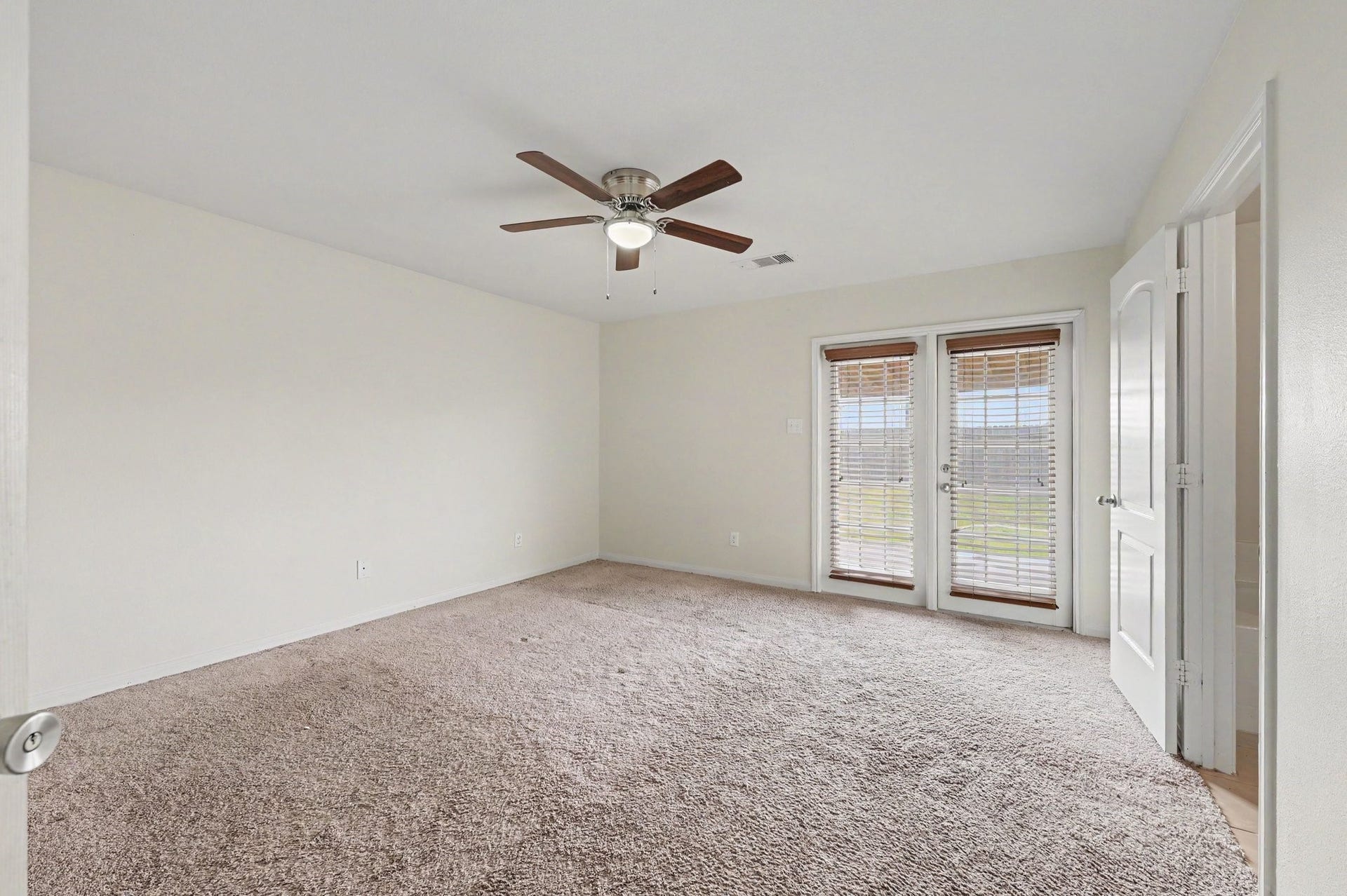 Primary Suite that features large windows with welcoming natural light.
