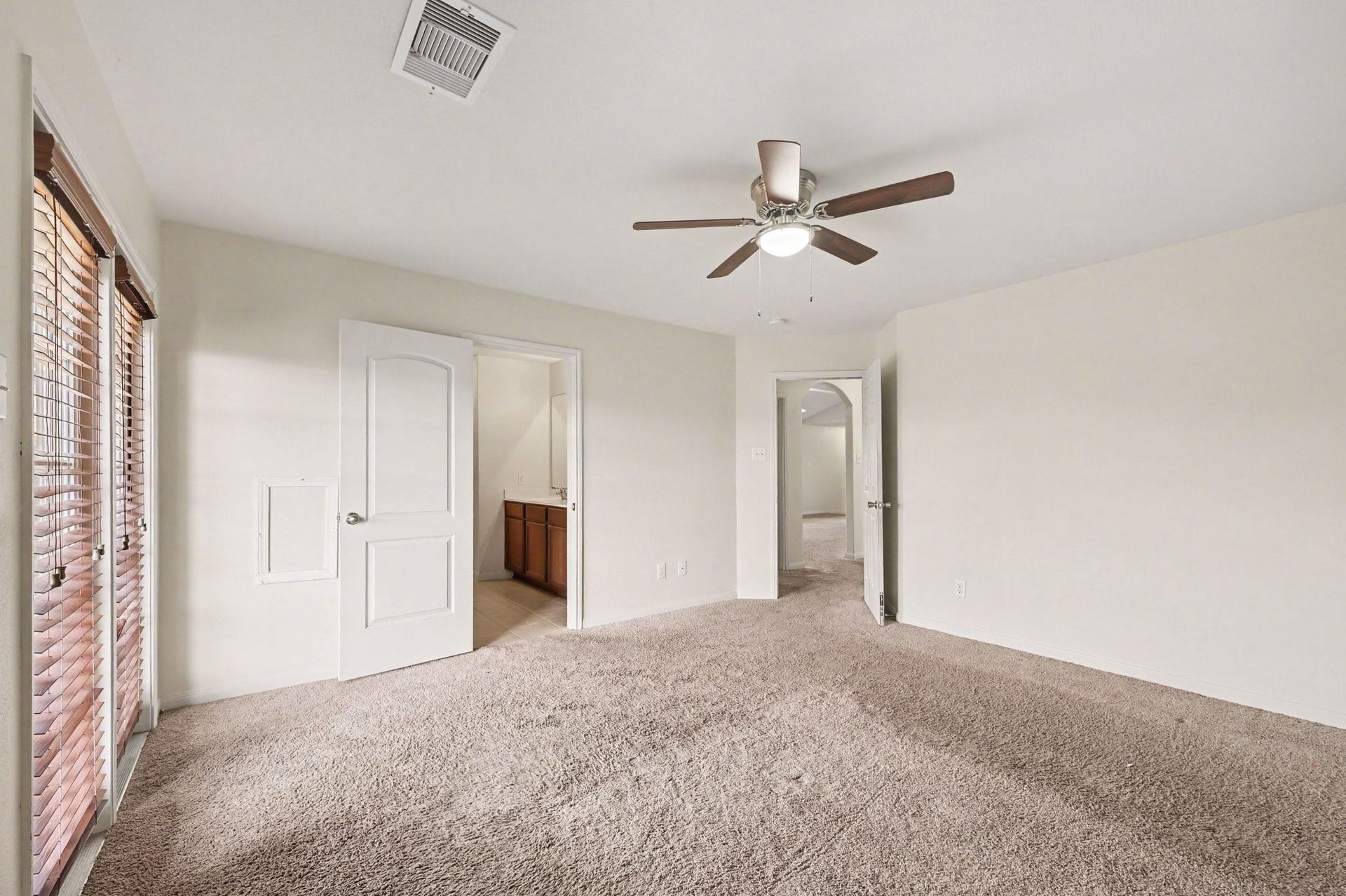 Primary Suite that features large windows with welcoming natural light.