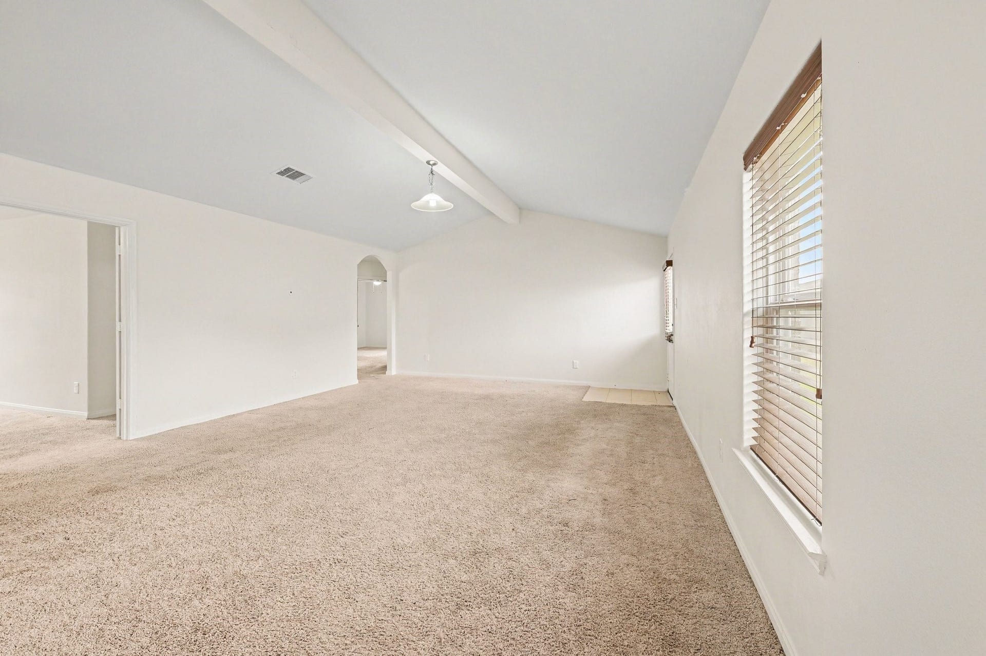 Living Room with vaulted ceilings that bring in plenty of natural light.