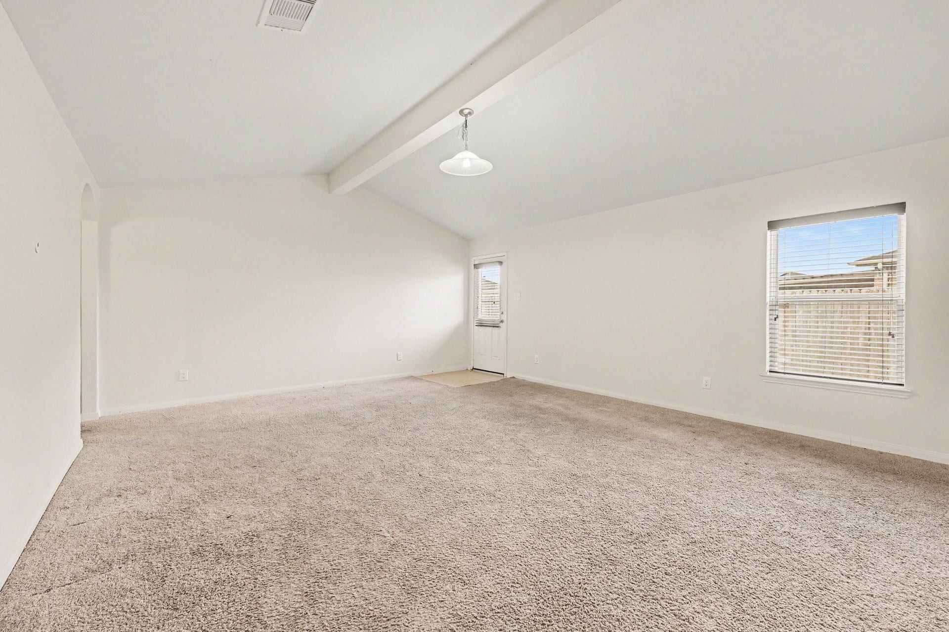 Living Room with vaulted ceilings that bring in plenty of natural light.