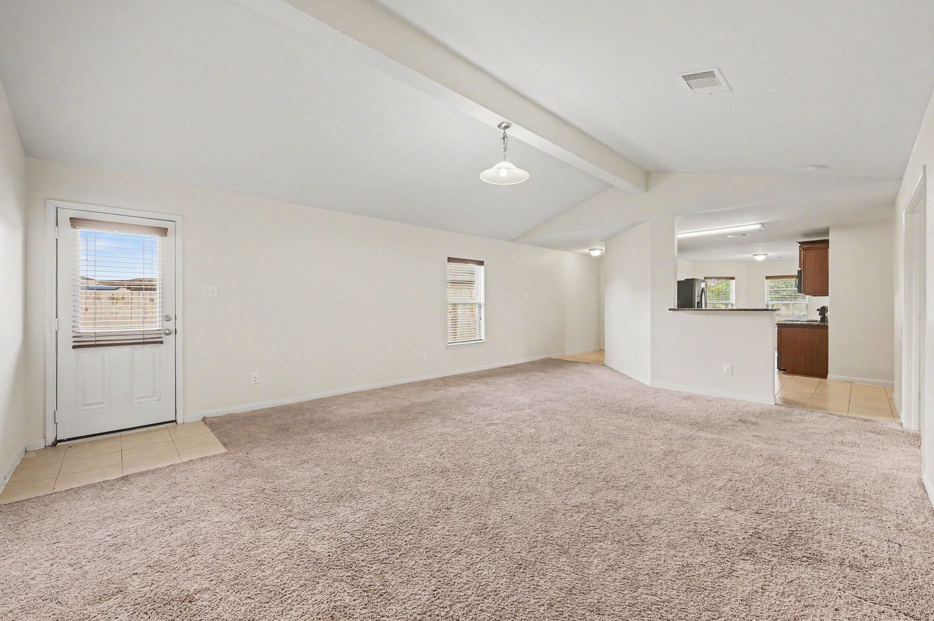 Living Room with vaulted ceilings that bring in plenty of natural light.