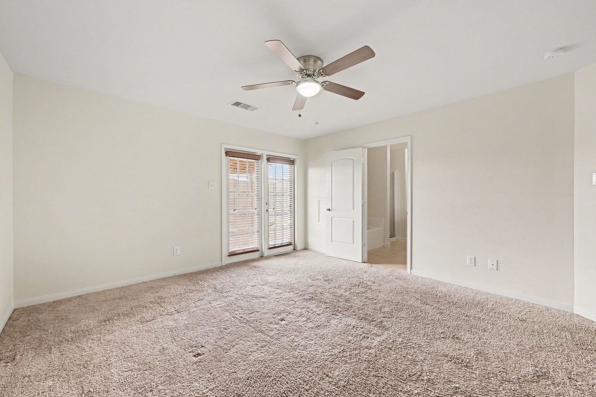 Primary Suite that features large windows with welcoming natural light.