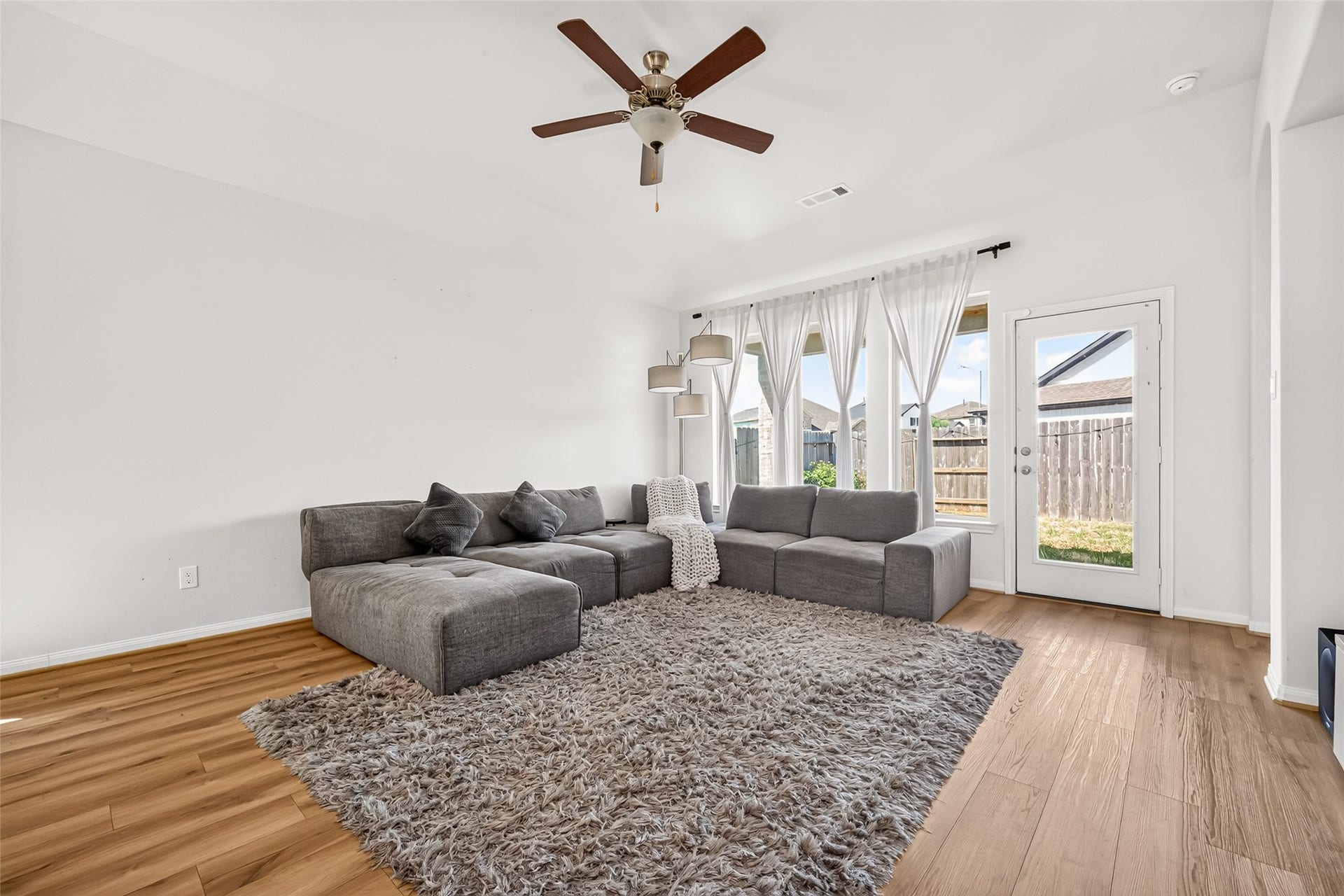 Living Room with Covered Back Patio Access and Large Windows giving tons of daylight