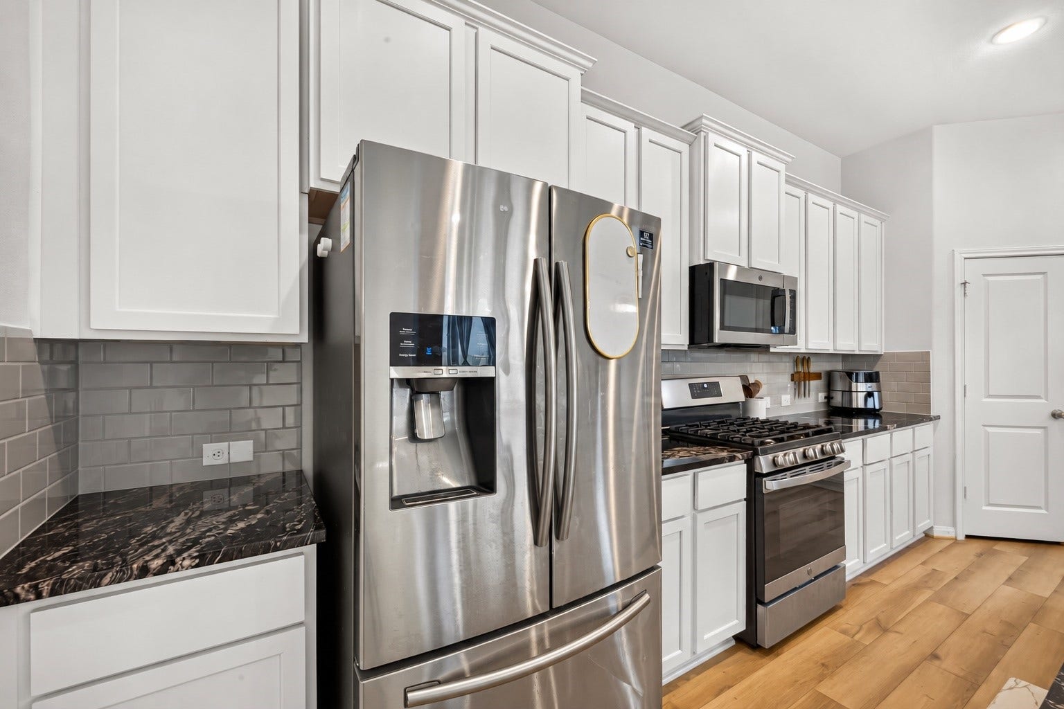 Open Concept Kitchen with Granite Counter Tops, SS Appliances and Large Serving Island amazing for entertaining.