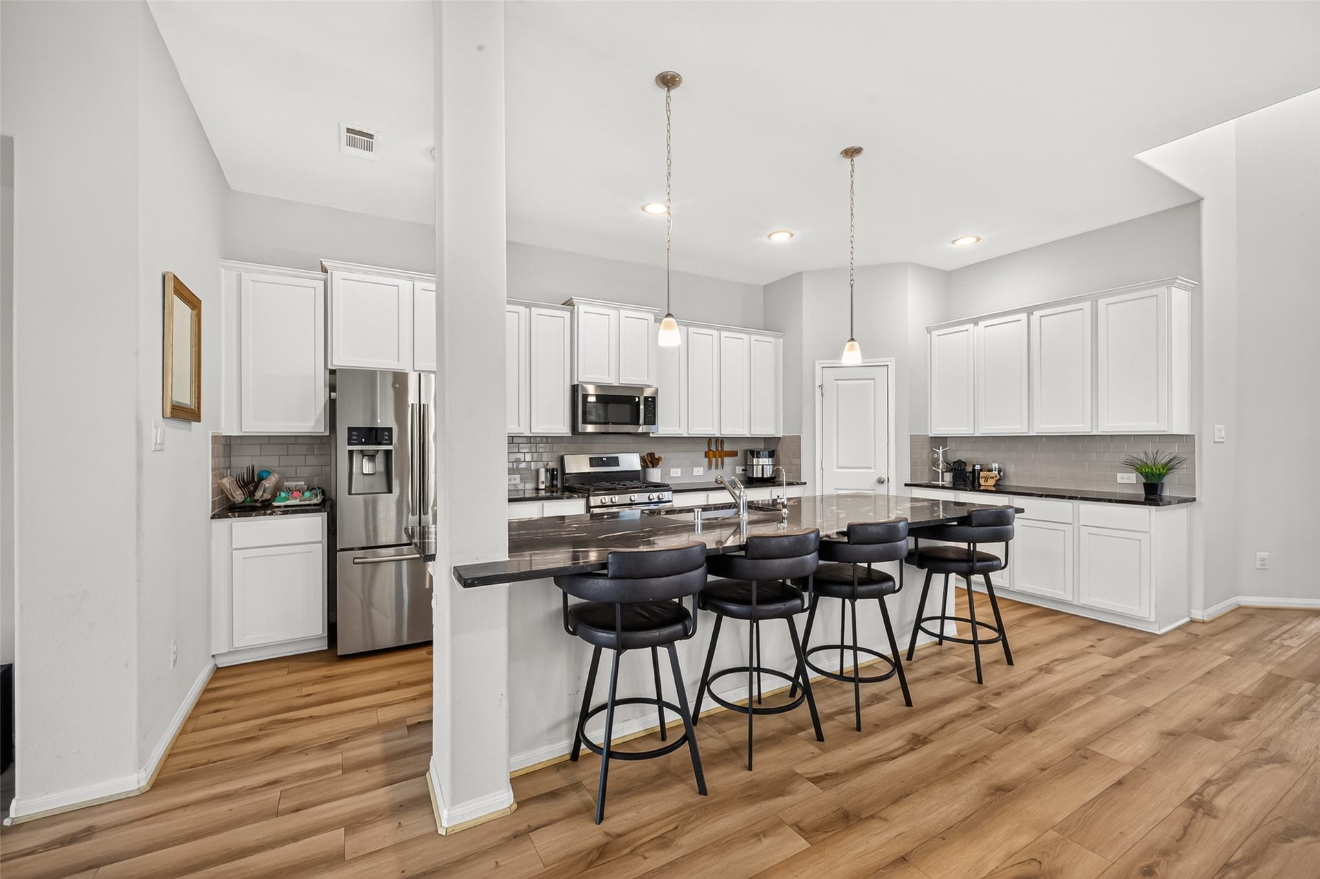 Open Concept Kitchen with Granite Counter Tops, SS Appliances and Large Serving Island amazing for entertaining.