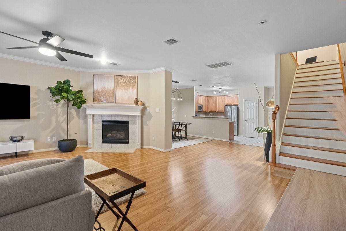 Wood look flooring extends gracefully throughout the living and dining room, enhancing the natural light in this space!