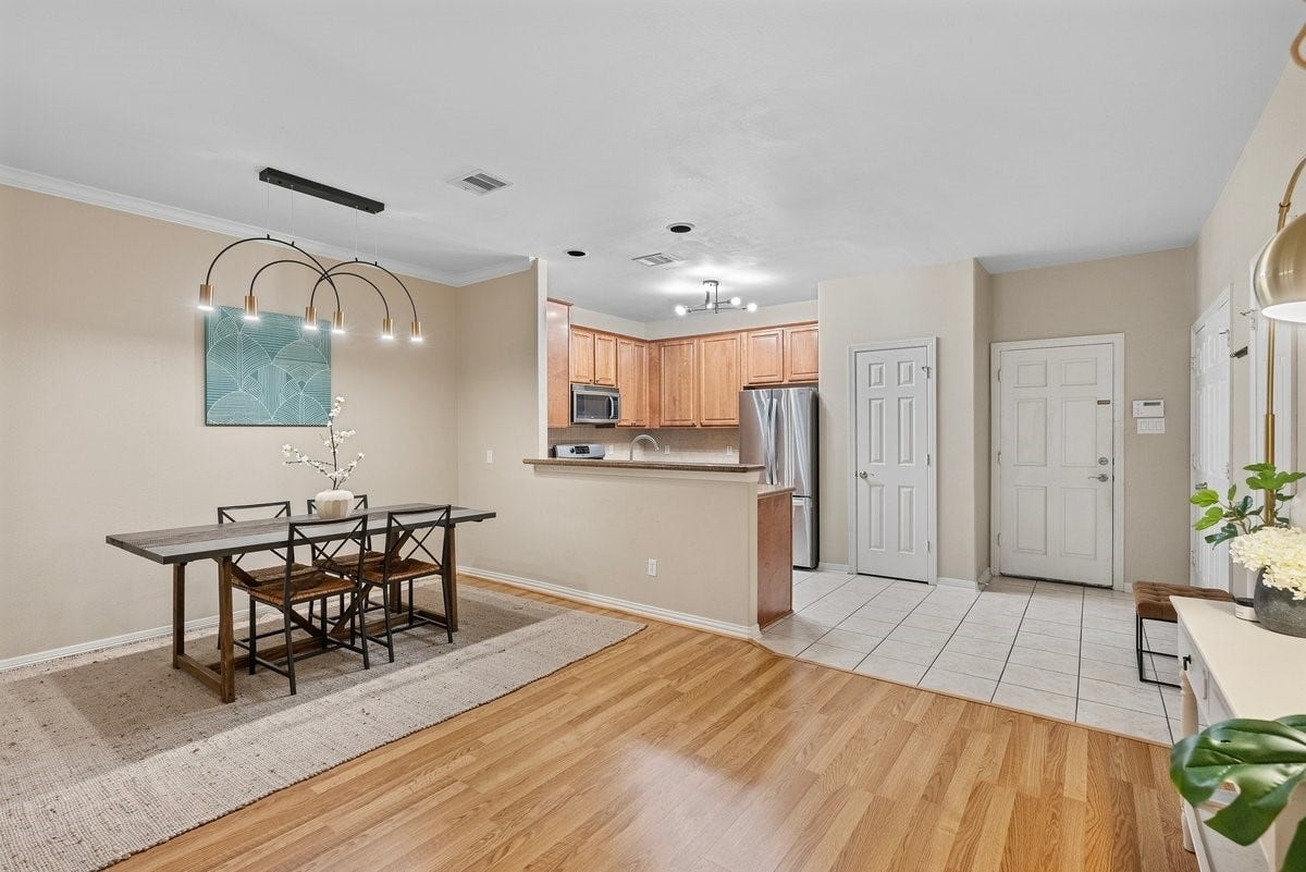 Enjoy delicious meals in this dining area equipped with a modern chandelier!