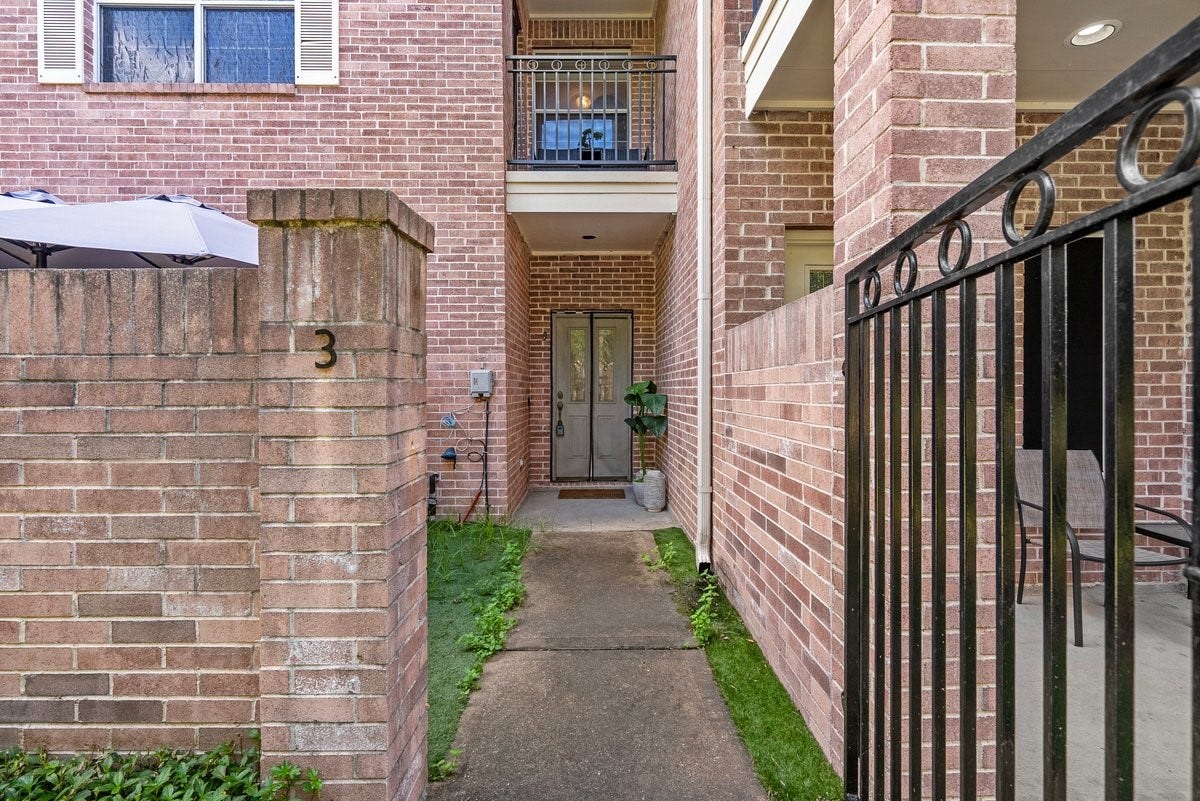 Step through the gates into a courtyard at the entrance of the home.