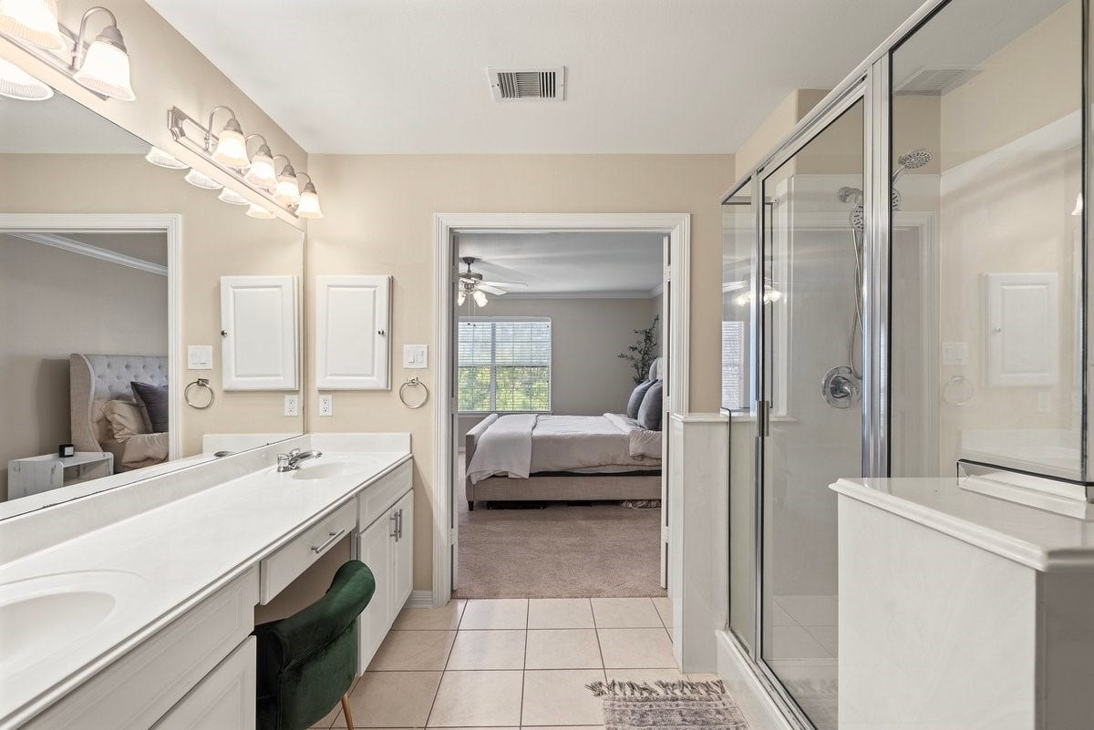 Getting ready for the day is a breeze in this beautiful primary bathroom! It has extended counterspace, large shower, and enormous mirror!
