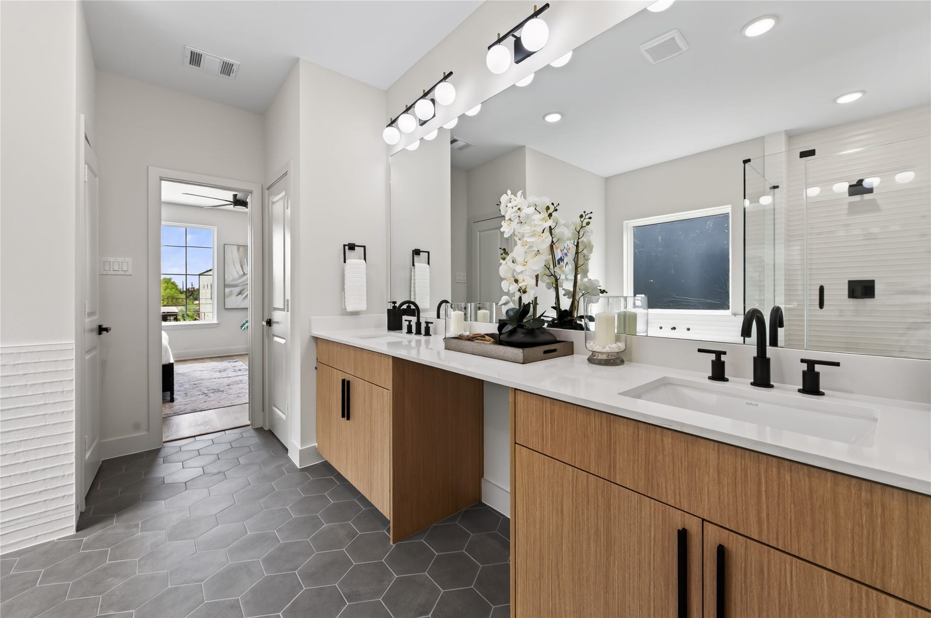 Luxurious primary bathroom is elegant as it is grand.