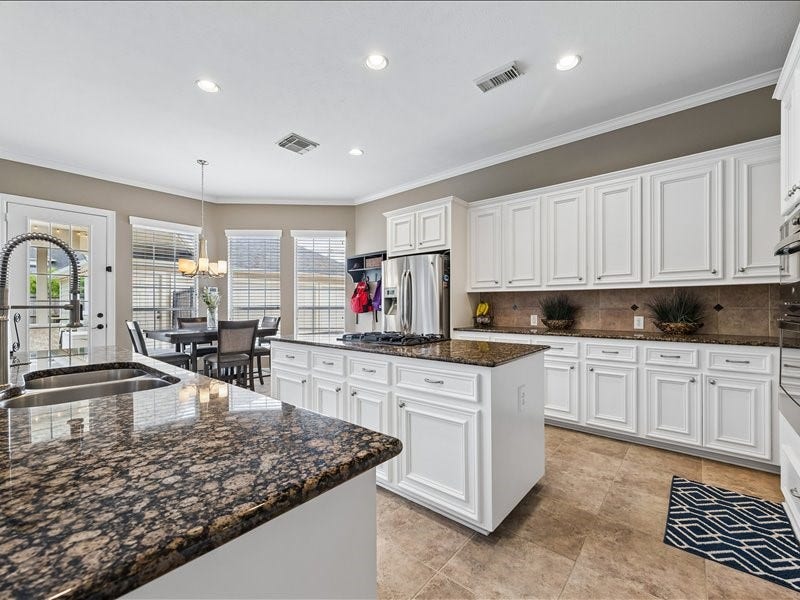 9007 Avebury Stone Circle, Missouri City, TX 77459 Another view of your beautiful kitchen with raised-panel cabinetry and stainless-steel appliances.
