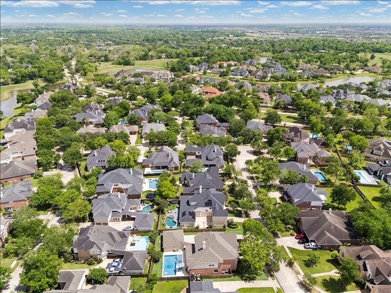 9007 Avebury Stone Circle, Missouri City, TX 77459 Wide-angle aerial reveals a lush, well-established neighborhood dotted with pools, mature trees, and quality homesthe perfect setting for a lifestyle defined by comfort, privacy, and community. A place youll truly love to call home.
