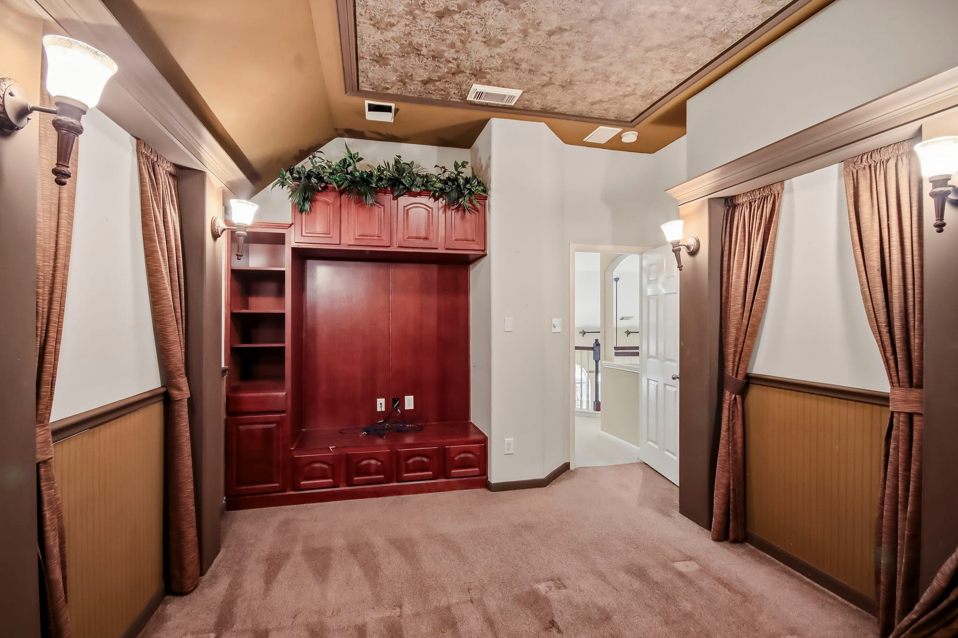 Private movie room featuring dark-tinted walls and a step-down design, creating the perfect theater-like atmosphere to relax and enjoy your favorite movies in the comfort of your own home!