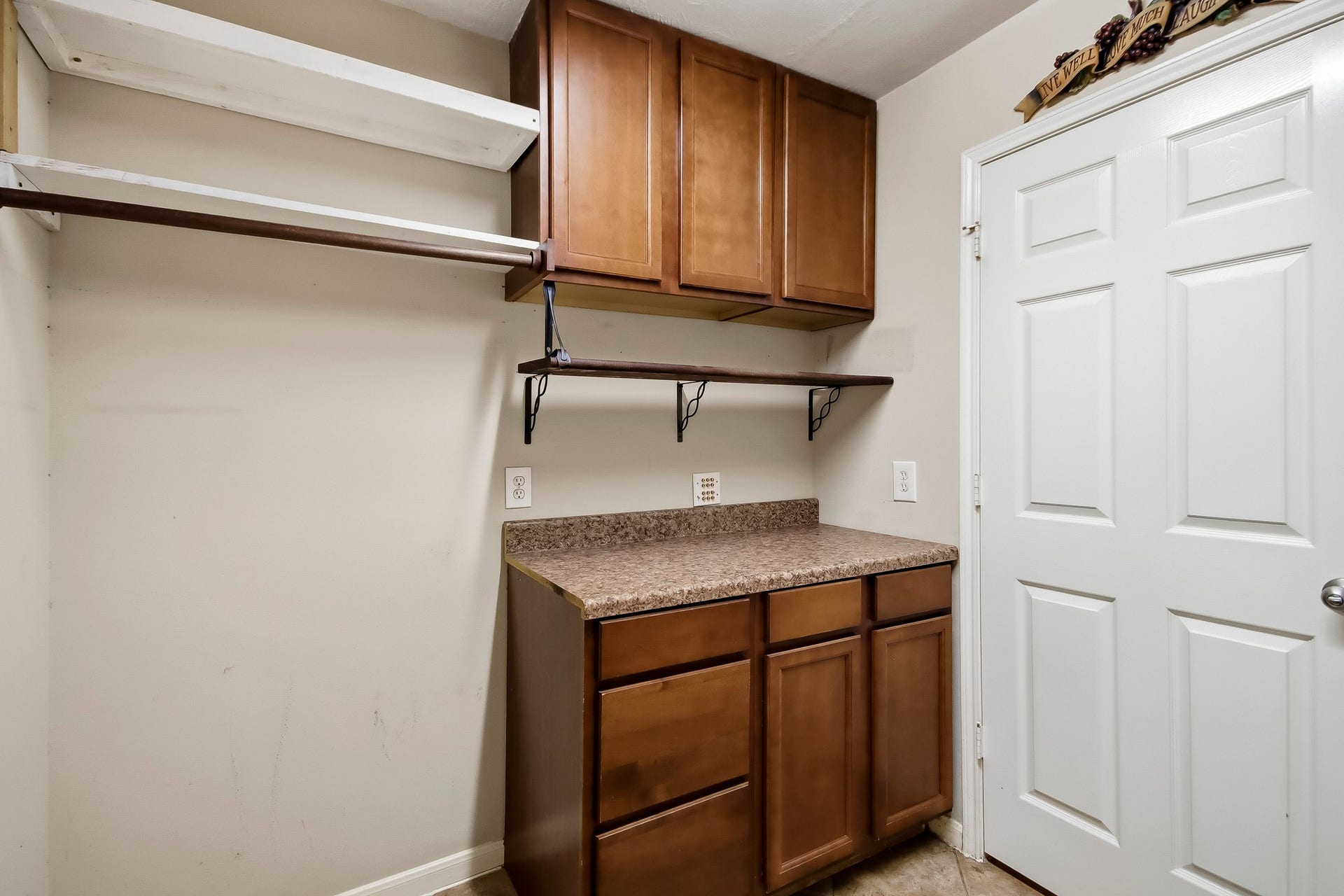 Conveniently located laundry room near the garage, featuring built-in cabinetry for extra storage and organization, making everyday chores a breeze!