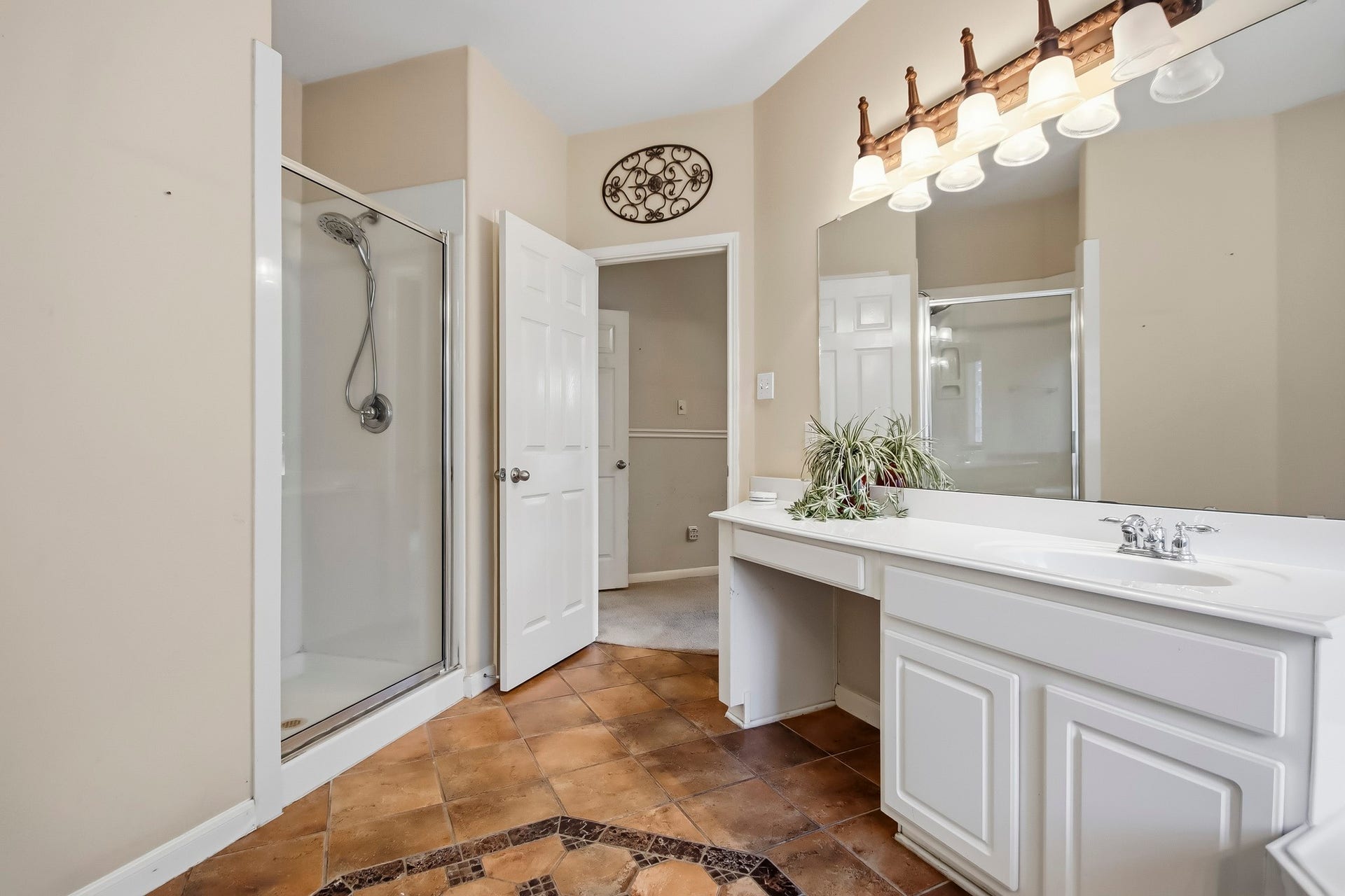 Spacious primary bathroom featuring a relaxing soaking tub, separate glass-enclosed shower, and generously spaced vanities with ample countertop space and storage for added comfort and convenience.
