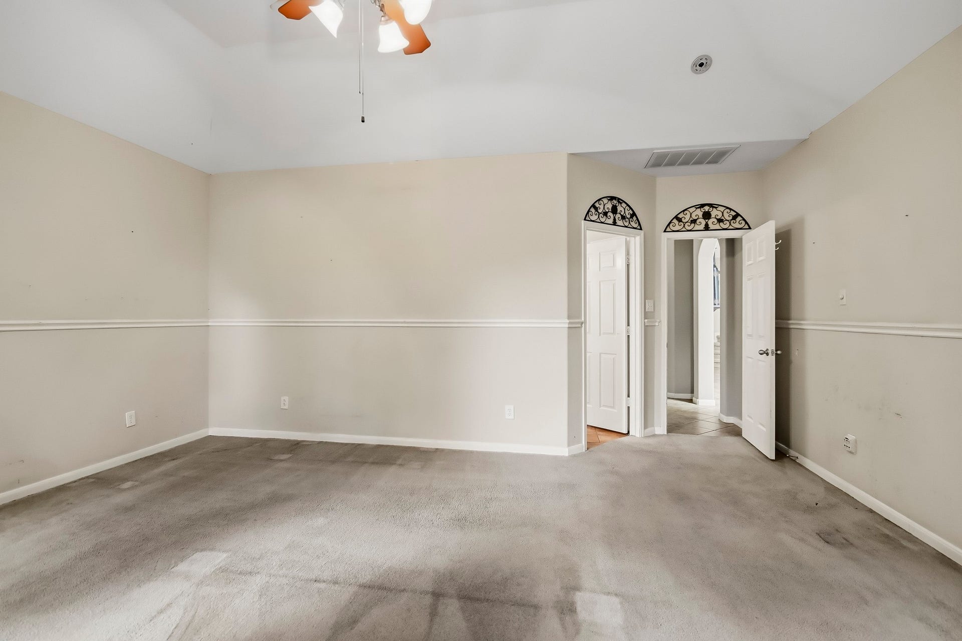 Spacious primary bedroom conveniently located on the first floor, offering comfort, privacy, and easy access to the home's main living areas.