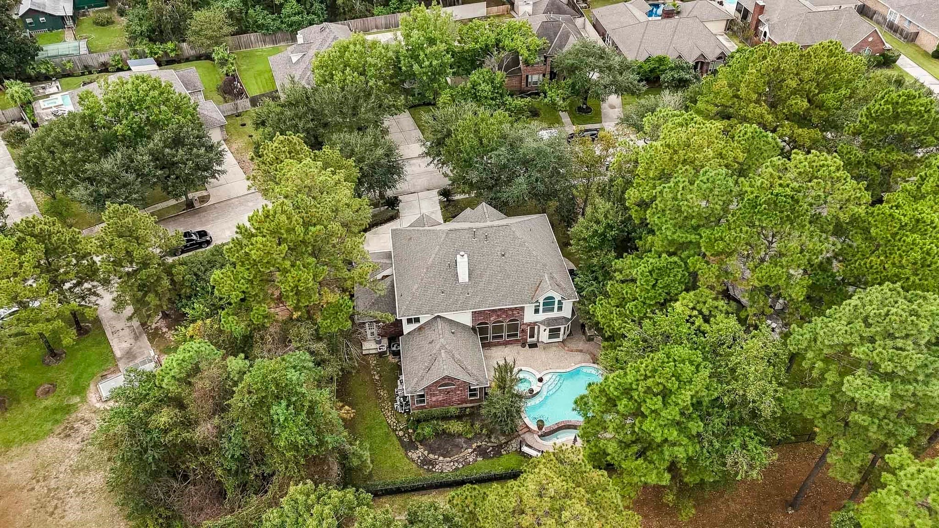 Breathtaking birds-eye view of this beautiful golf course home, surrounded by majestic mature trees and featuring a sparkling private pool, offering the perfect blend of luxury, privacy, and scenic beauty!