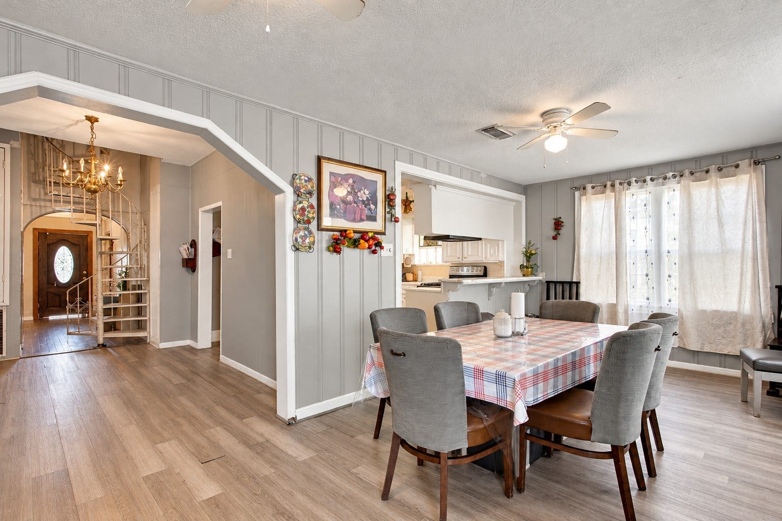 2120 Everett Street, Houston, TX 77009 Dining area featuring natural light, a ceiling fan, and convenient access to the kitchen and main entryway.
