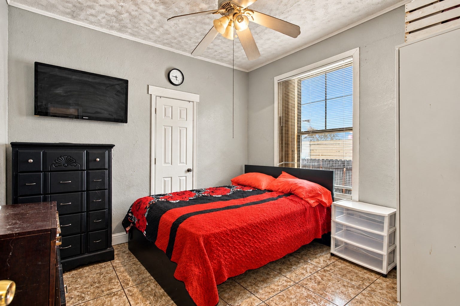 2120 Everett Street, Houston, TX 77009 Bedroom with natural light, tile flooring, a ceiling fan, and an driveway-facing window.