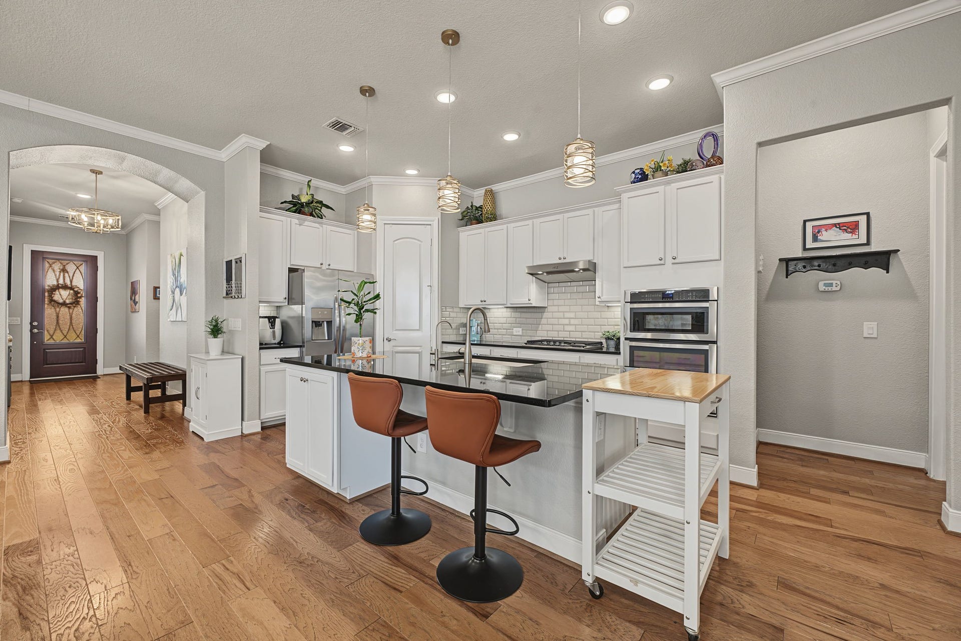 229 Percheron Drive, Spring, TX 77382 Large center island with sink and barstool seating. Note the width between the Kitchen and Family Room which is not visible here.