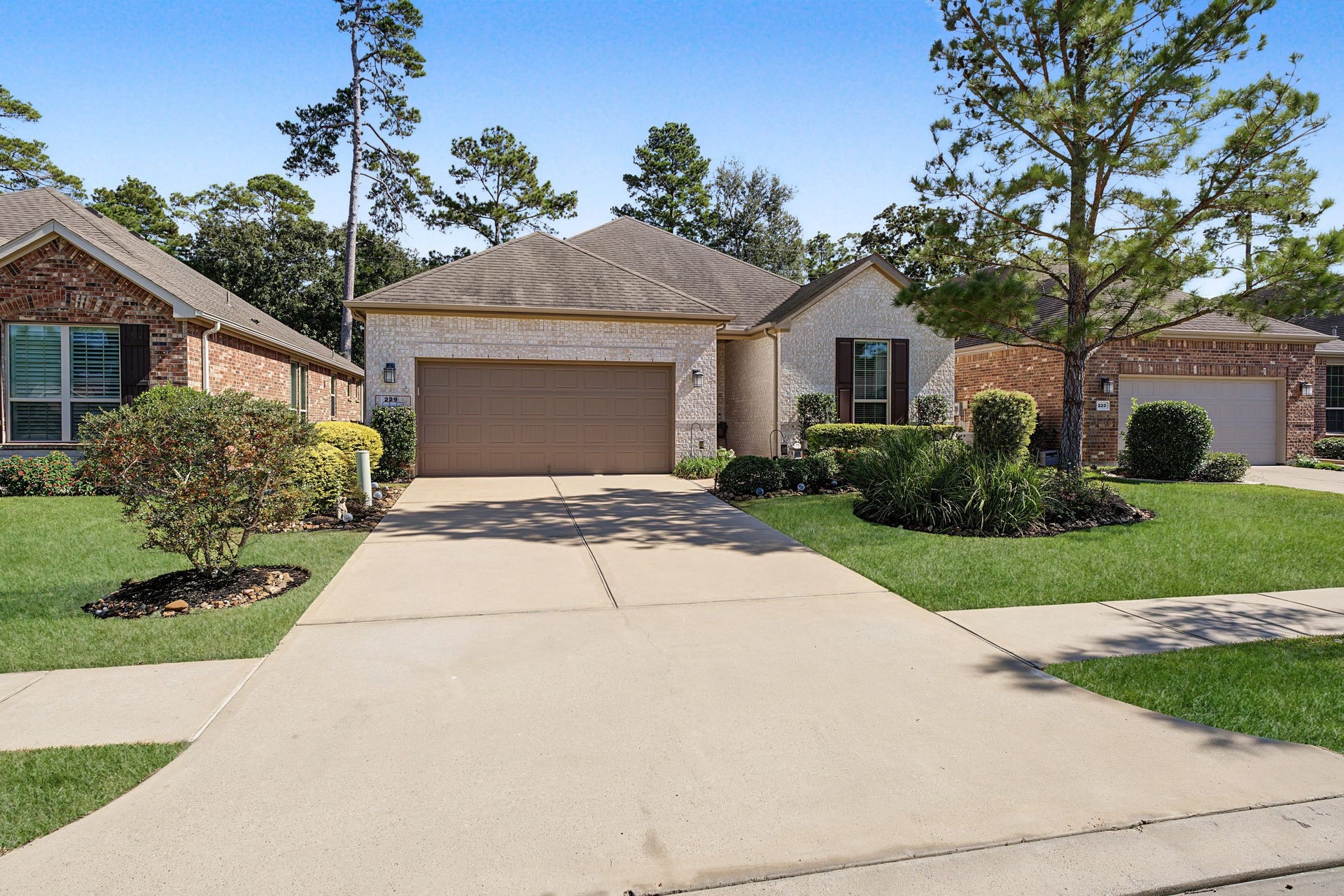 229 Percheron Drive, Spring, TX 77382 Long, double-wide driveway leading to the attached garage. Sidewalk community inside the gates.