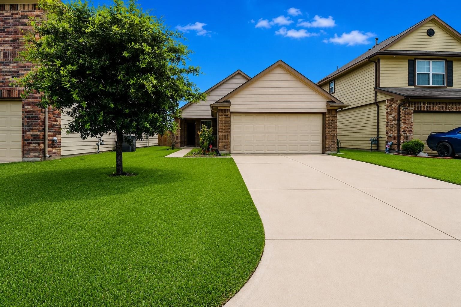 12710 City Green Trail, Houston, TX 77044 Charming suburban home with a two-car garage, well-maintained lawn, and a mature tree in the front yard. The property features a spacious driveway and is situated in a neighborhood with similar style houses.