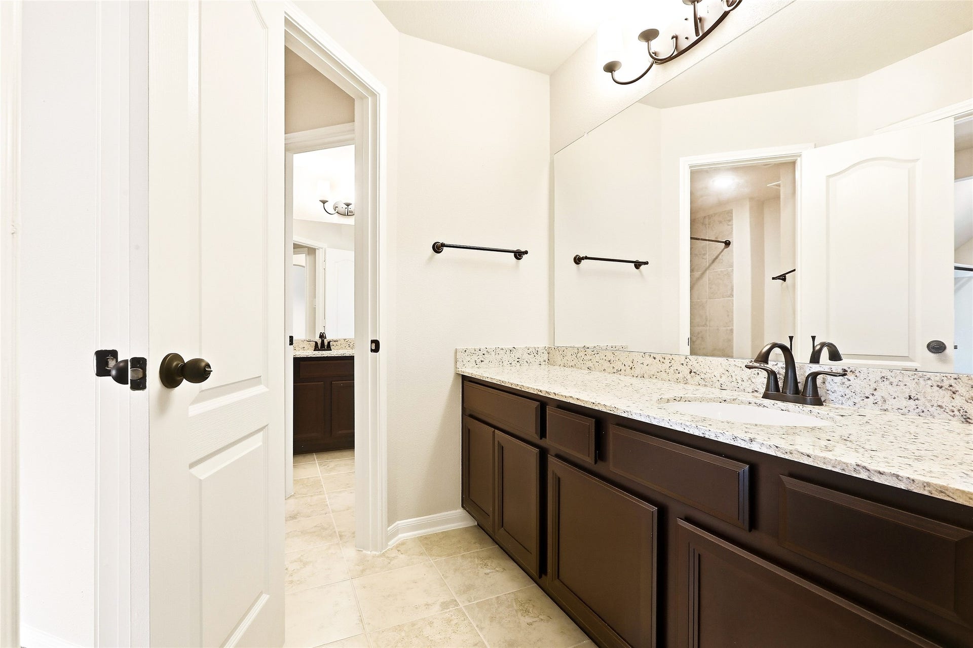 Bedroom connected to bathroom with separate sinks