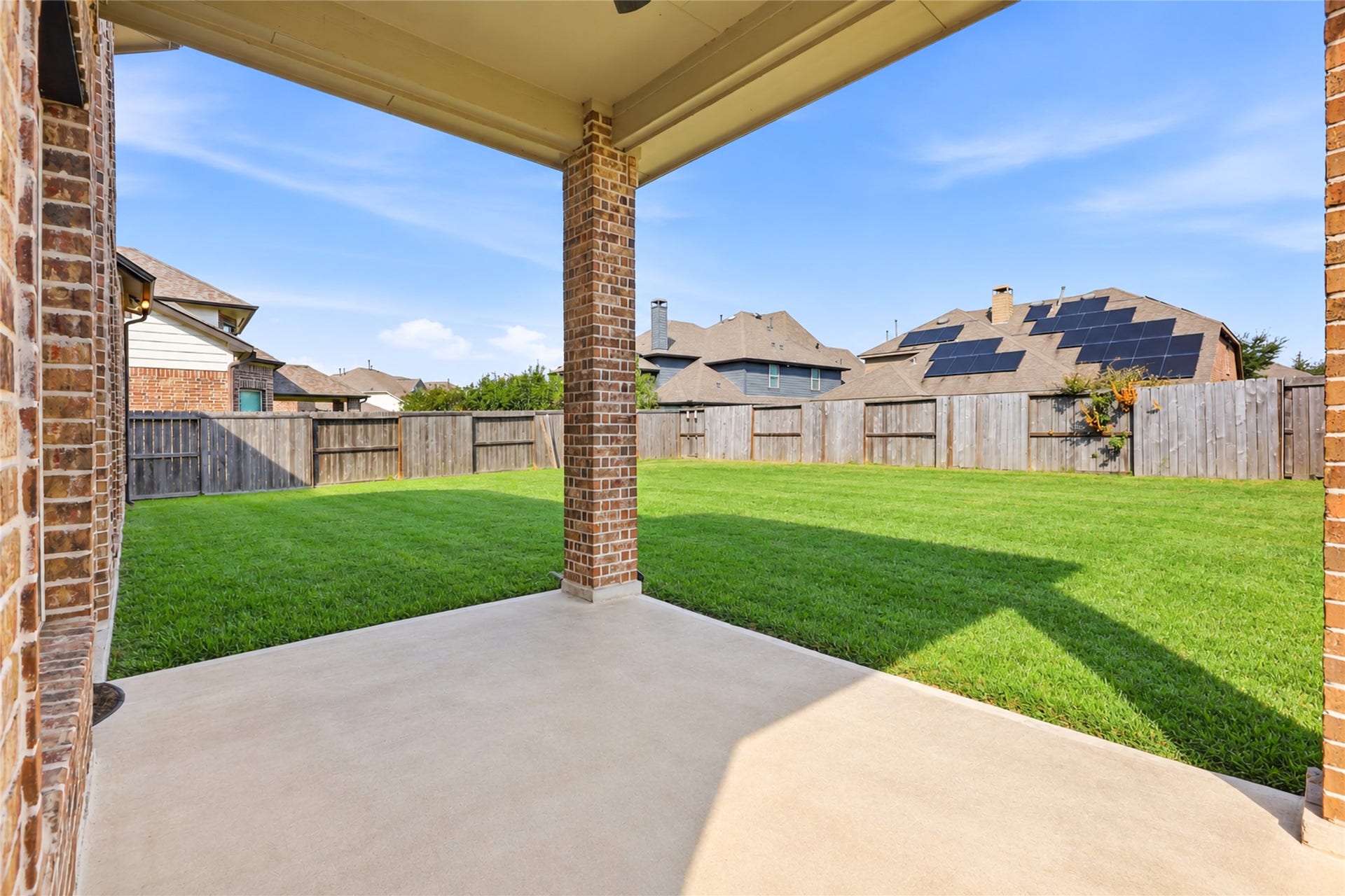 Covered patio overlooking backyard that can also be extended