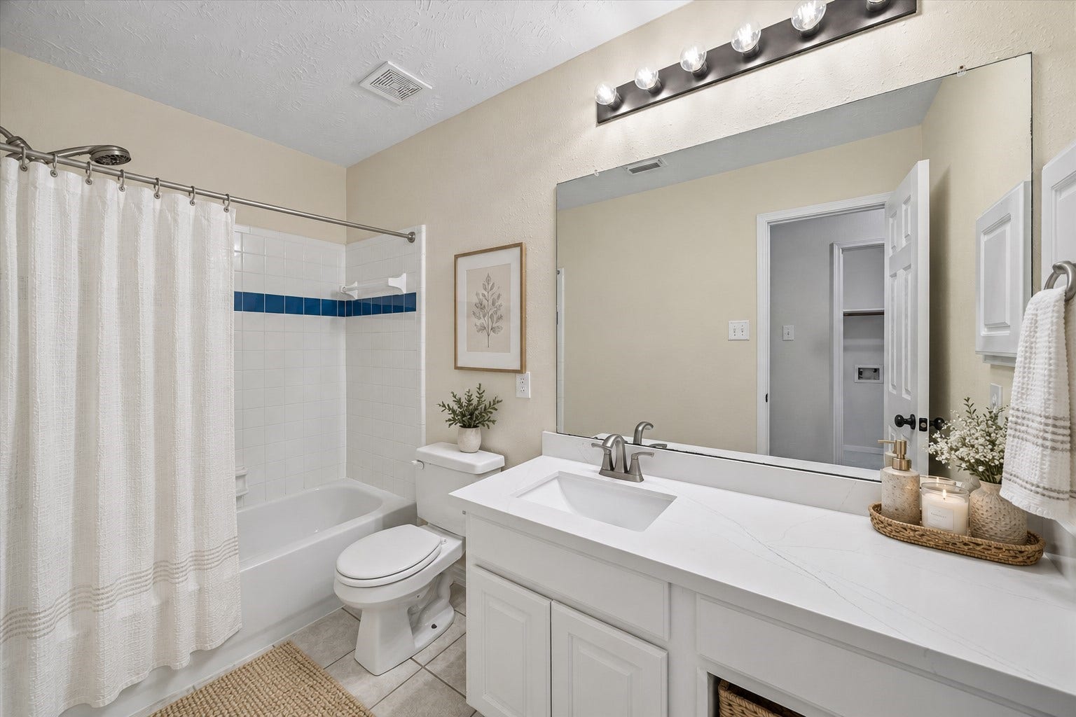 11 Merryvale Drive, The Woodlands, TX 77382 The secondary bathroom features a tub/shower combination and lots of countertop space! Virtually staged with accessories.