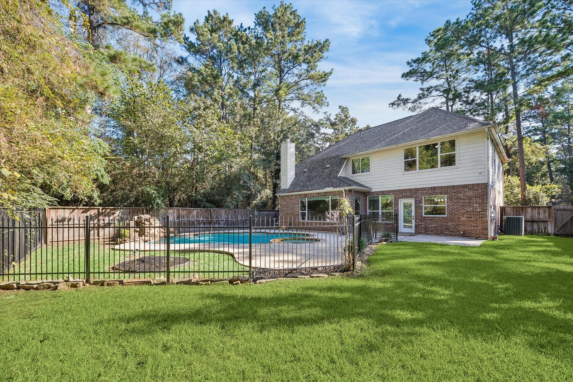 11 Merryvale Drive, The Woodlands, TX 77382 This rear view of the home truly showcases the generous lot size!