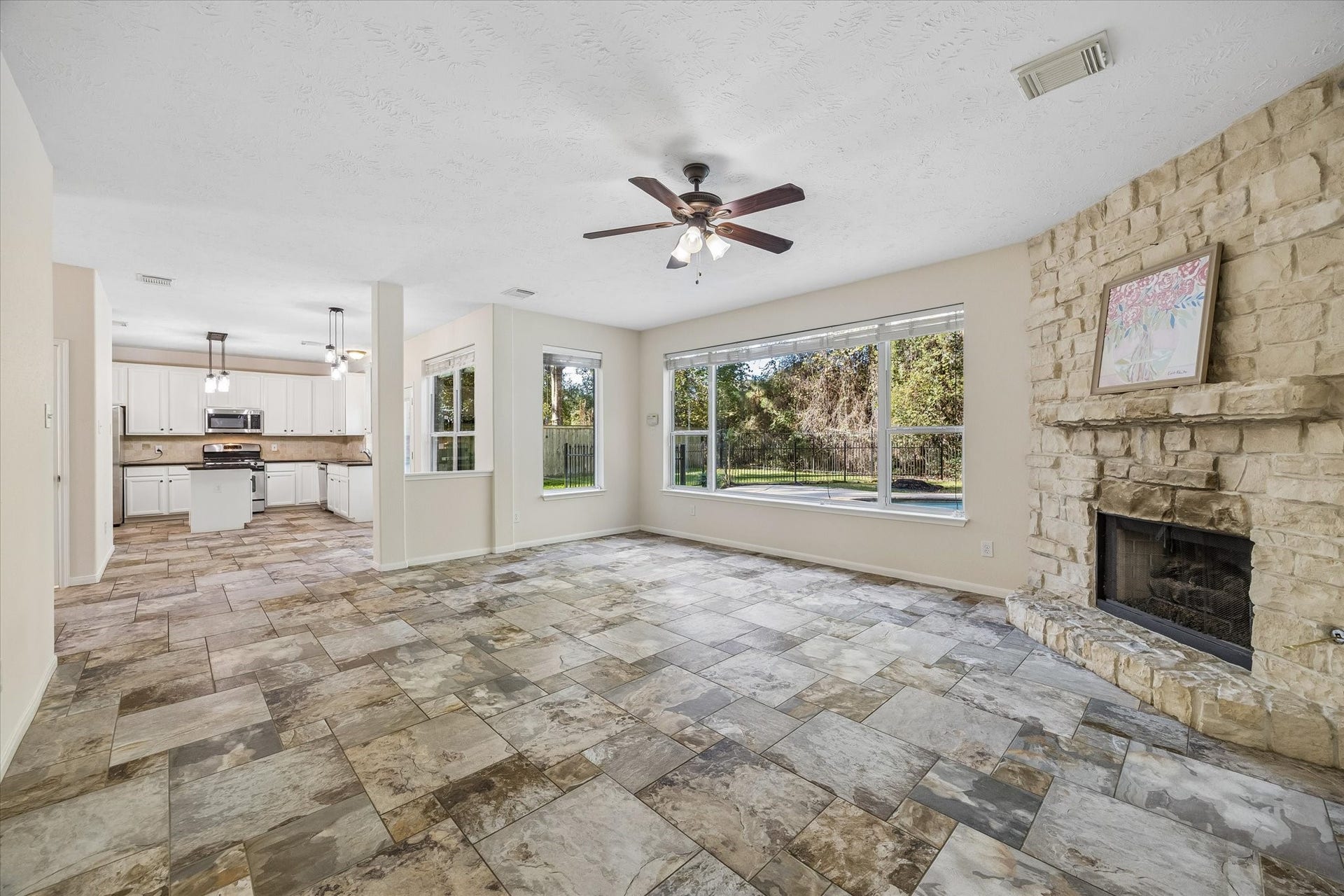 11 Merryvale Drive, The Woodlands, TX 77382 The open-concept floor plan seamlessly connects the living area to the kitchen, creating a spacious and inviting layout.