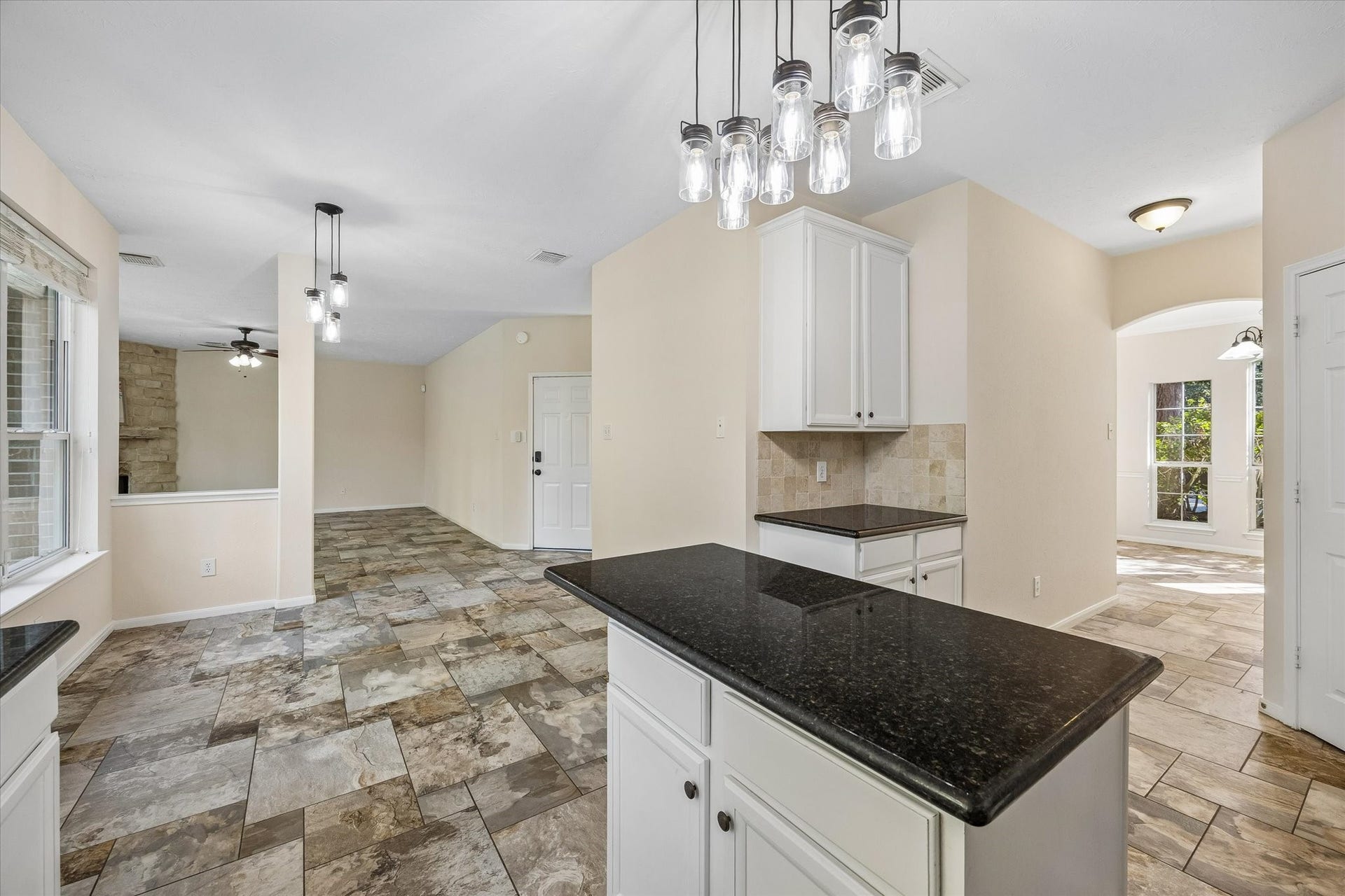 11 Merryvale Drive, The Woodlands, TX 77382 The open-concept layout seamlessly connects the kitchen to the surrounding living and dining spaces, creating a spacious, functional flow throughout the home.