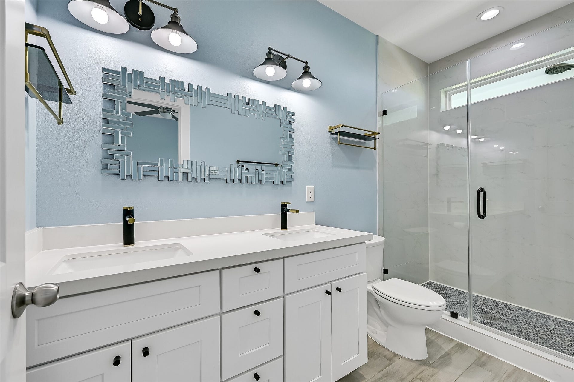 3911 Warrior Court, Galveston, TX 77554 The primary bathroom is complete with quartz countertops, double vanities and a walk-in shower.