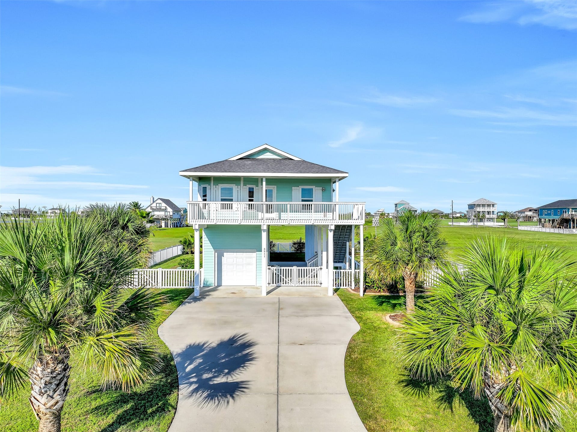 3911 Warrior Court, Galveston, TX 77554 Beautiful landscaping can be found throughout the property, adding to the homes curb appeal.