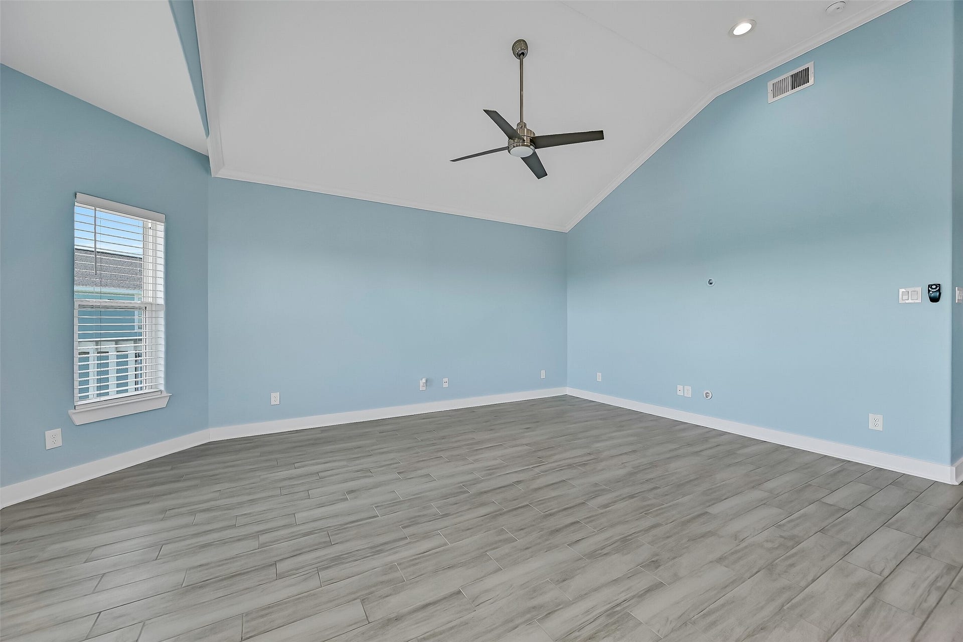 3911 Warrior Court, Galveston, TX 77554 The living room boasts ample windows and soaring ceilings, creating a bright and open feel.