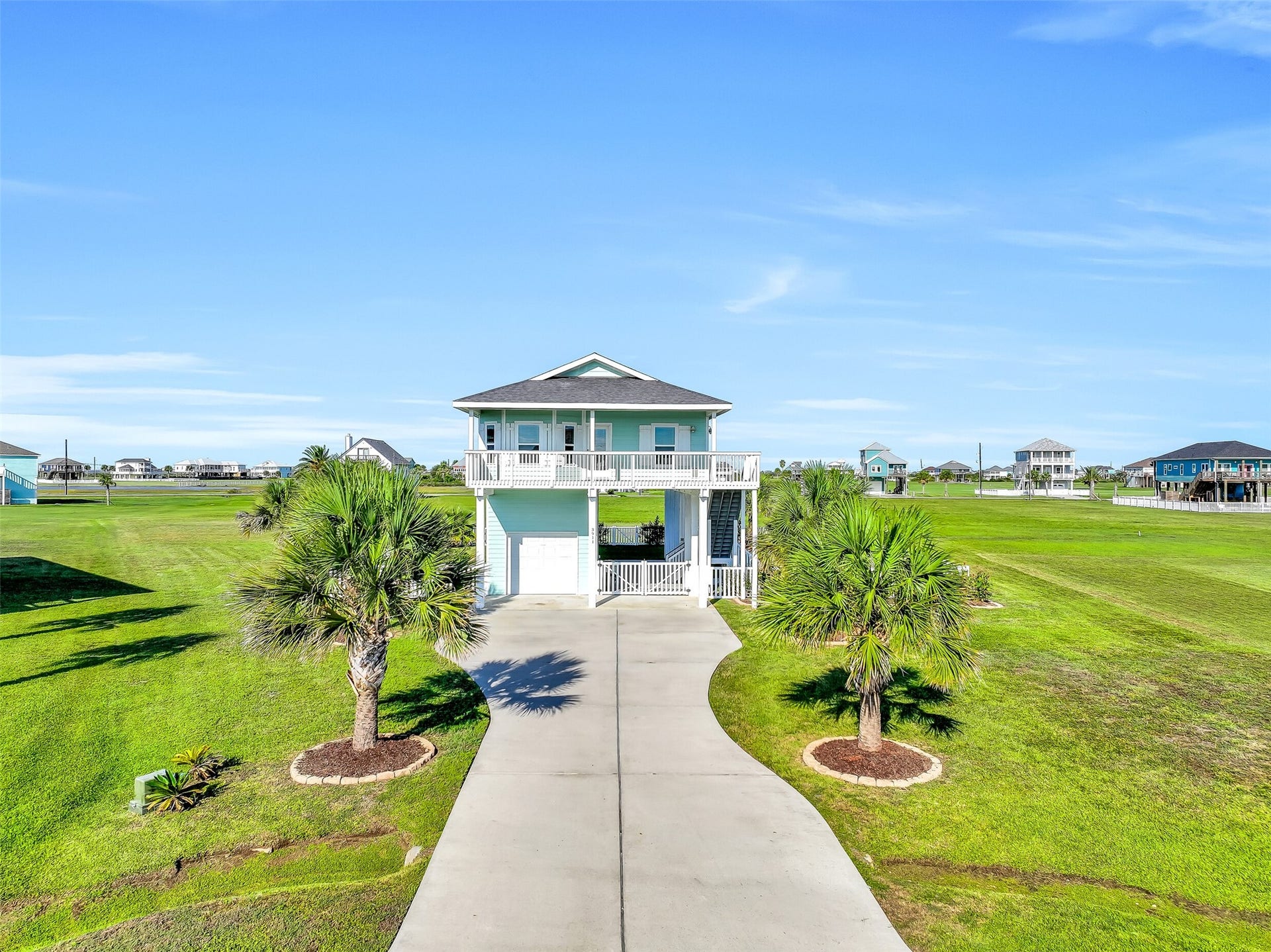 3911 Warrior Court, Galveston, TX 77554 Situated on a spacious lot, this home offers water views from multiple decks, a one-car garage, and a double-wide driveway with plenty of parking.