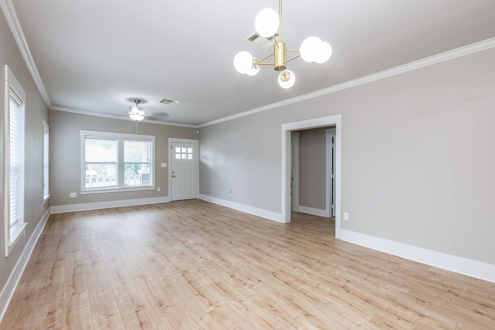 1307 Walton Street, Houston, TX 77009 Light-filled room showcasing recently installed vinyl plank flooring.