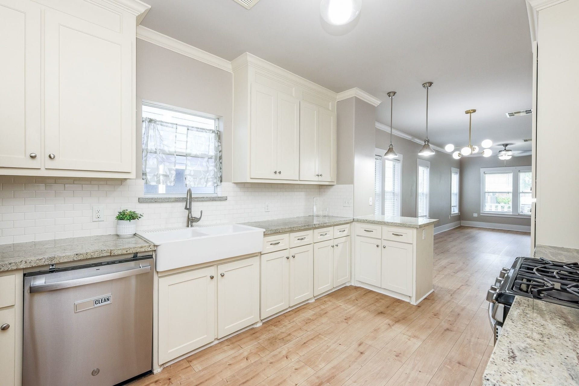 1307 Walton Street, Houston, TX 77009 Kitchen made for your inner chef, featuring elegant off-white cabinets, sleek countertops, and a chic subway tile backsplash.