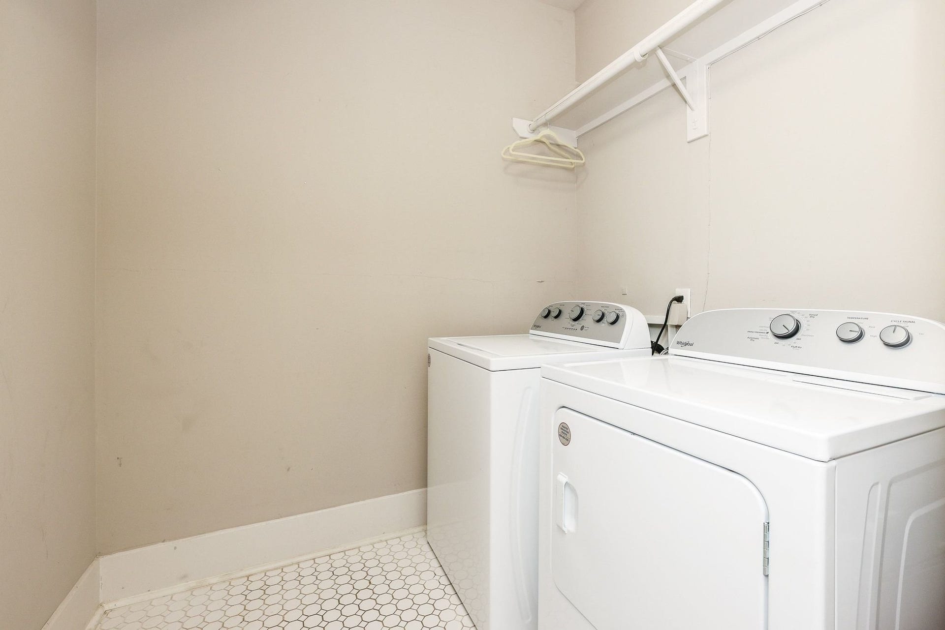 1307 Walton Street, Houston, TX 77009 Laundry space featuring tile flooring and a built-in storage shelf.