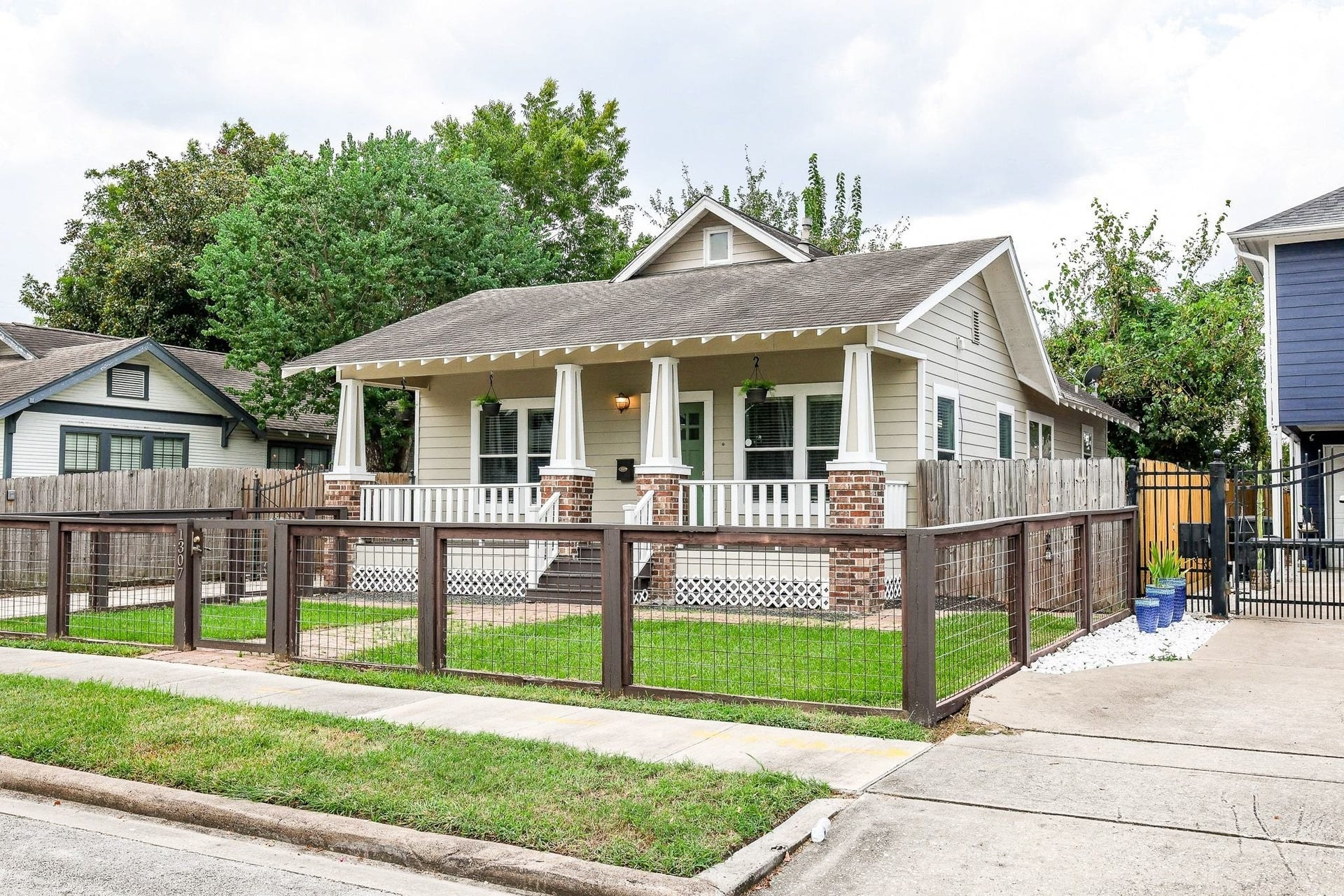 1307 Walton Street, Houston, TX 77009 Charming single-story home featuring a welcoming front porch, brick accents, and a neutral color palette throughout.