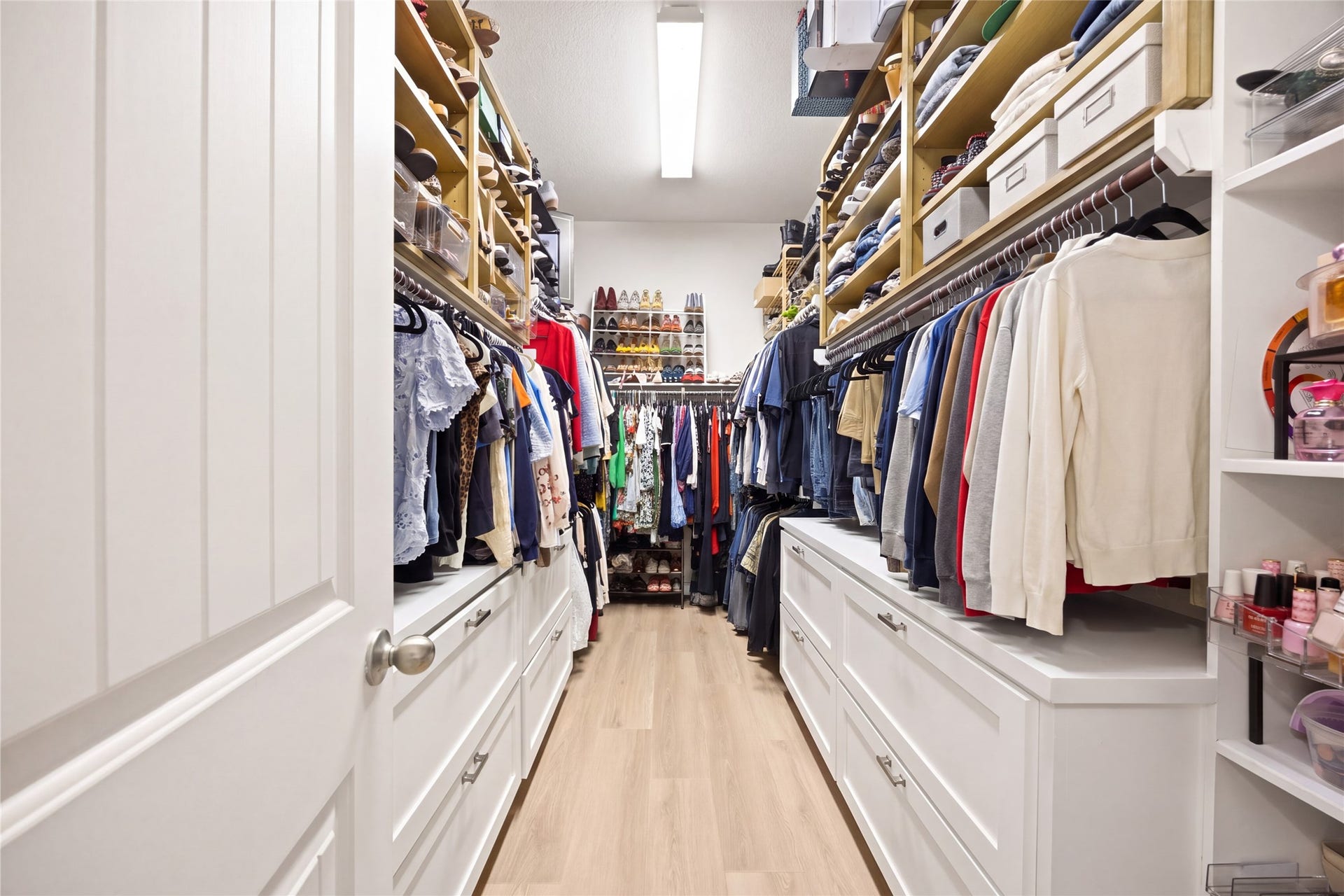 9612 Eden Ridge Lane, Pearland, TX 77584 PRIMARY CLOSET Spacious walk-in primary closet featuring extensive custom built-ins, shelving, hanging space, and drawer storage.