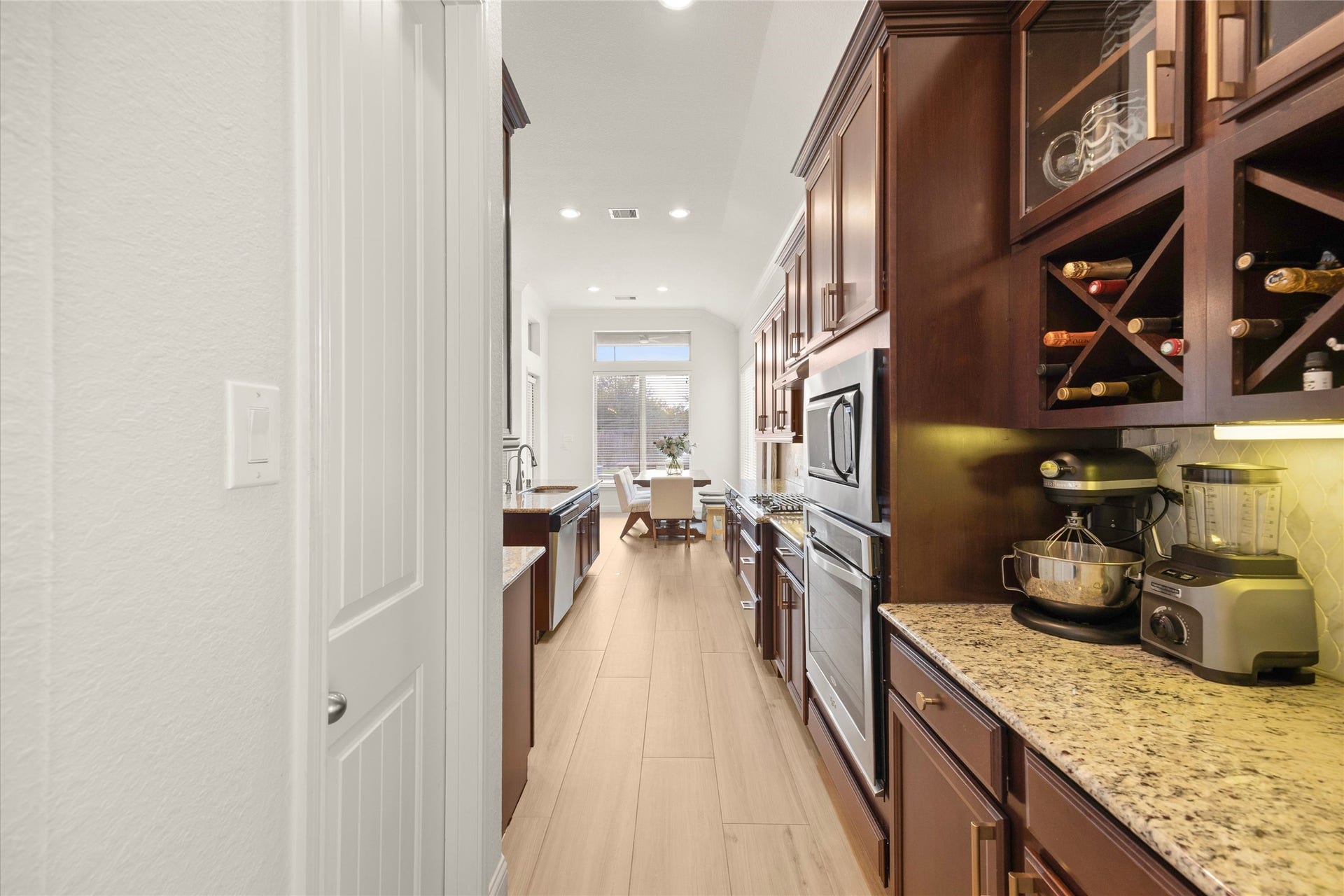 9612 Eden Ridge Lane, Pearland, TX 77584 KITCHEN III Extended kitchen cabinetry provides additional prep and storage space, complete a built-in wine rack.